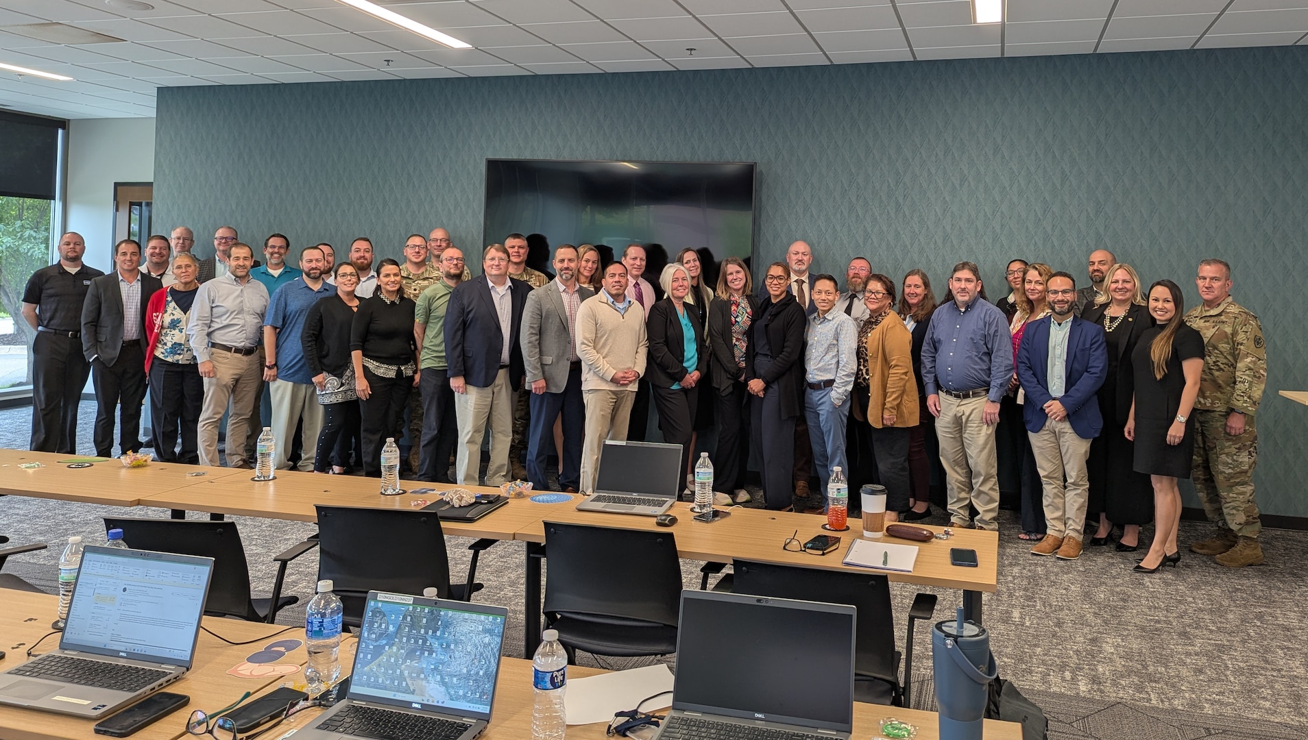 A smiling group of men and women pose for a picture