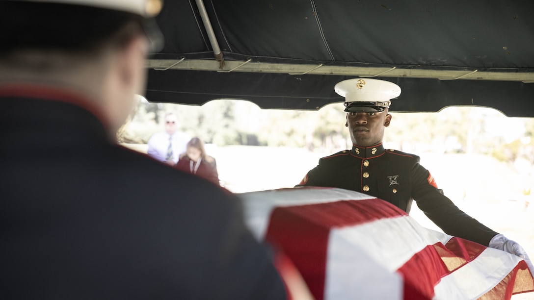 U.S. Marine Corps Lance Cpl. Moses James, system engineer, Headquarters Battalion, Marine Forces Reserve, prepares to remove and fold a U.S. flag draped over the casket of Sgt. Frank Schmaltz at the Garden of Memories Funeral Home and Cemetery, Metairie, Louisiana, Oct. 13, 2025. Marine Corps Funeral Honors stands committed to ensuring that every Marine who has served receives the proper respects, serving as a final tribute to their life and a lasting demonstration of the nation's appreciation for their unwavering defense of our country, whether in times of conflict or peace. (U.S. Marine Corps photo by Lance Cpl. Van Hoang)