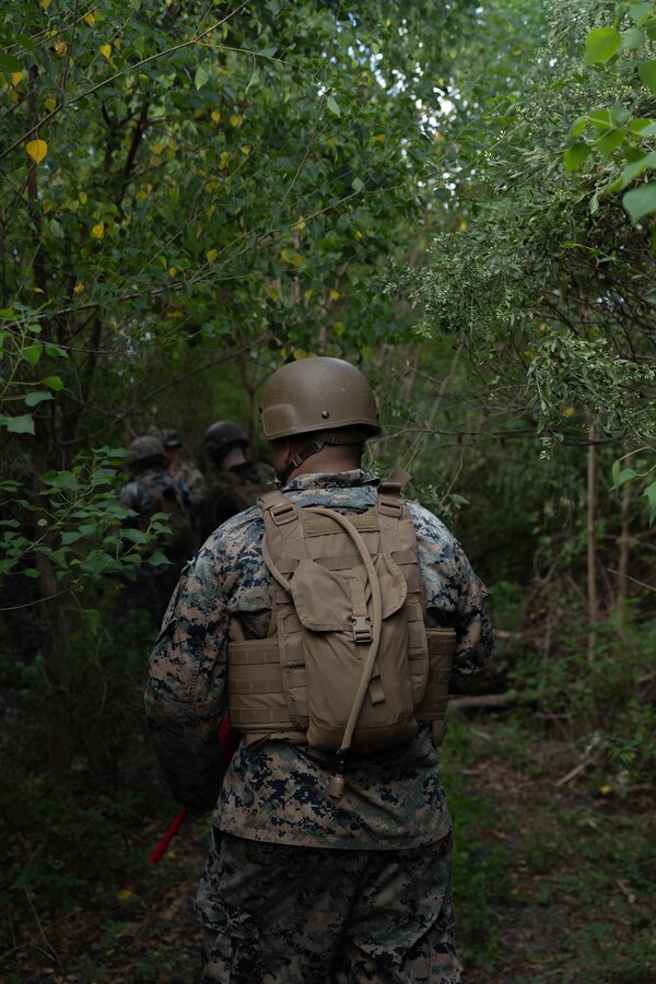 U.S. Marine Corps Cpl. Leonardo Murillo Trujillo, a military police officer with Headquarters Battalion, Marine Forces Reserve, patrols during the Corporals Course 4-25 field exercise, Naval Air Station-Joint Reserve Base New Orleans, Belle Chasse, Louisiana, Sept. 26, 2025.  The field exercise tested the Marines’ leadership, decision making, and small unit tactics in a simulated environment. (U.S. Marine Corps photo by Cpl. Kanoa Thomas)