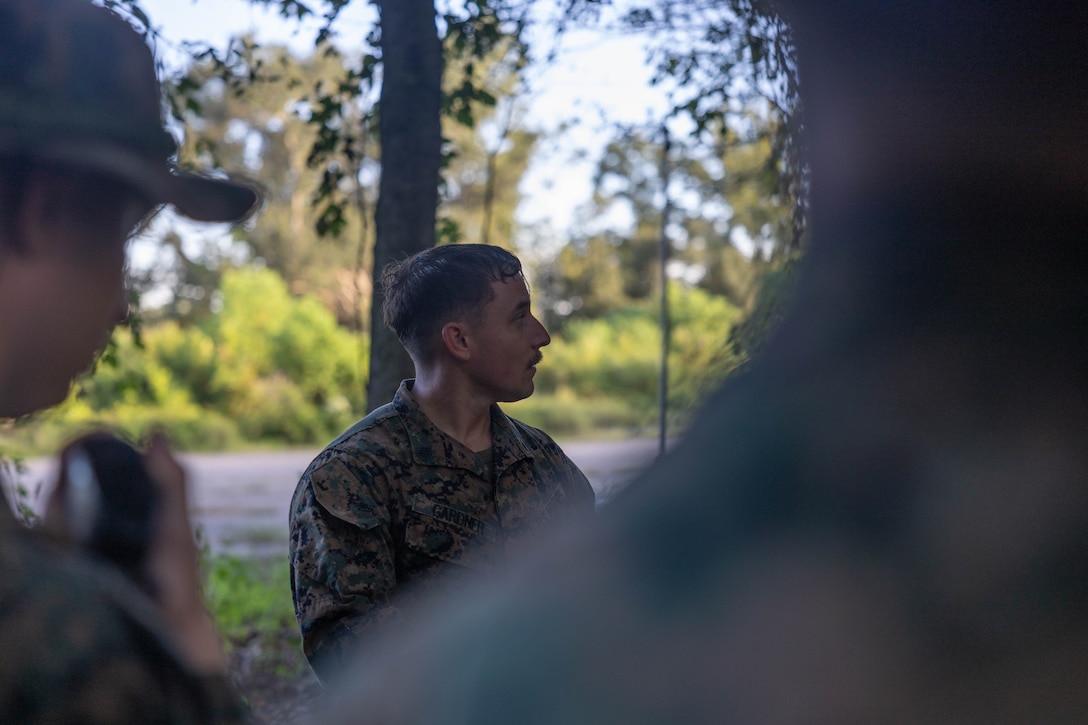 U.S. Marine Corps Staff Sgt. Anthony Gardner, the assistant operations chief with Headquarters Battalion, Marine Forces Reserve, briefs Marines before a land navigation course during the Corporals Course 4-25 field exercise, Naval Air Station-Joint Reserve Base New Orleans, Belle Chasse, Louisiana, Sept. 26, 2025.  The field exercise tested the Marines’ leadership, decision making and small-unit tactics in a simulated environment. (U.S. Marine Corps photo by Cpl. Kanoa Thomas)