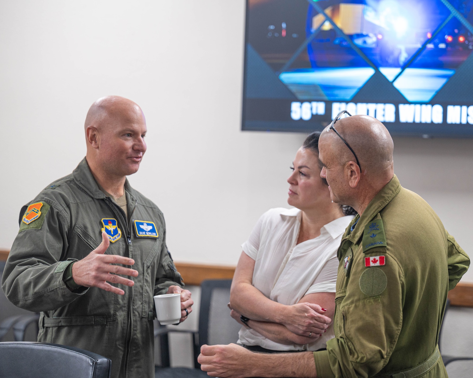 U.S. Air Force Brig. Gen. David Berkland, 56th Fighter Wing commander (left), Royal Canadian Air Force Crista-lynn Ferguson, Fighter Capabilities director general (middle), RCAF Brig. Gen. Jeff Davis, 1st Canadian Air Division deputy commander force generation, (right), converse with each other during a base visit, Oct. 28, 2025, at Luke Air Force Base, Arizona.
