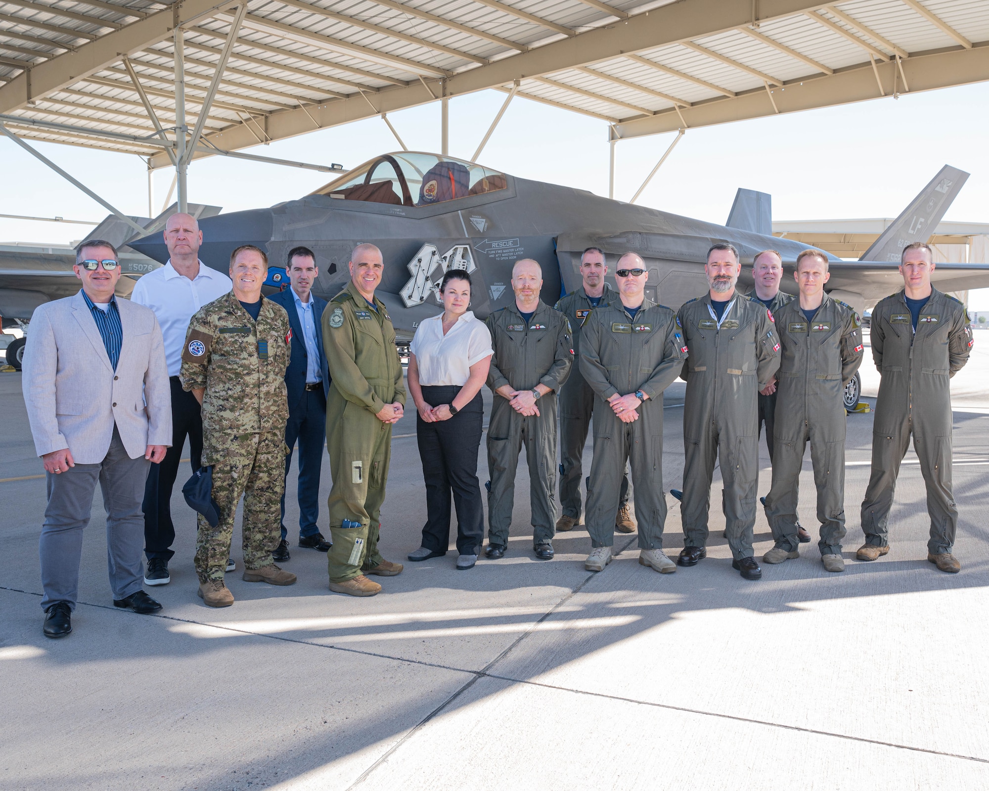 Members of the Royal Canadian Air Force pose for a group photo in front of an F-35A Lightning II assigned to Luke Air Force Base, during a base visit, Oct. 28, 2025, at Luke AFB, Arizona.
