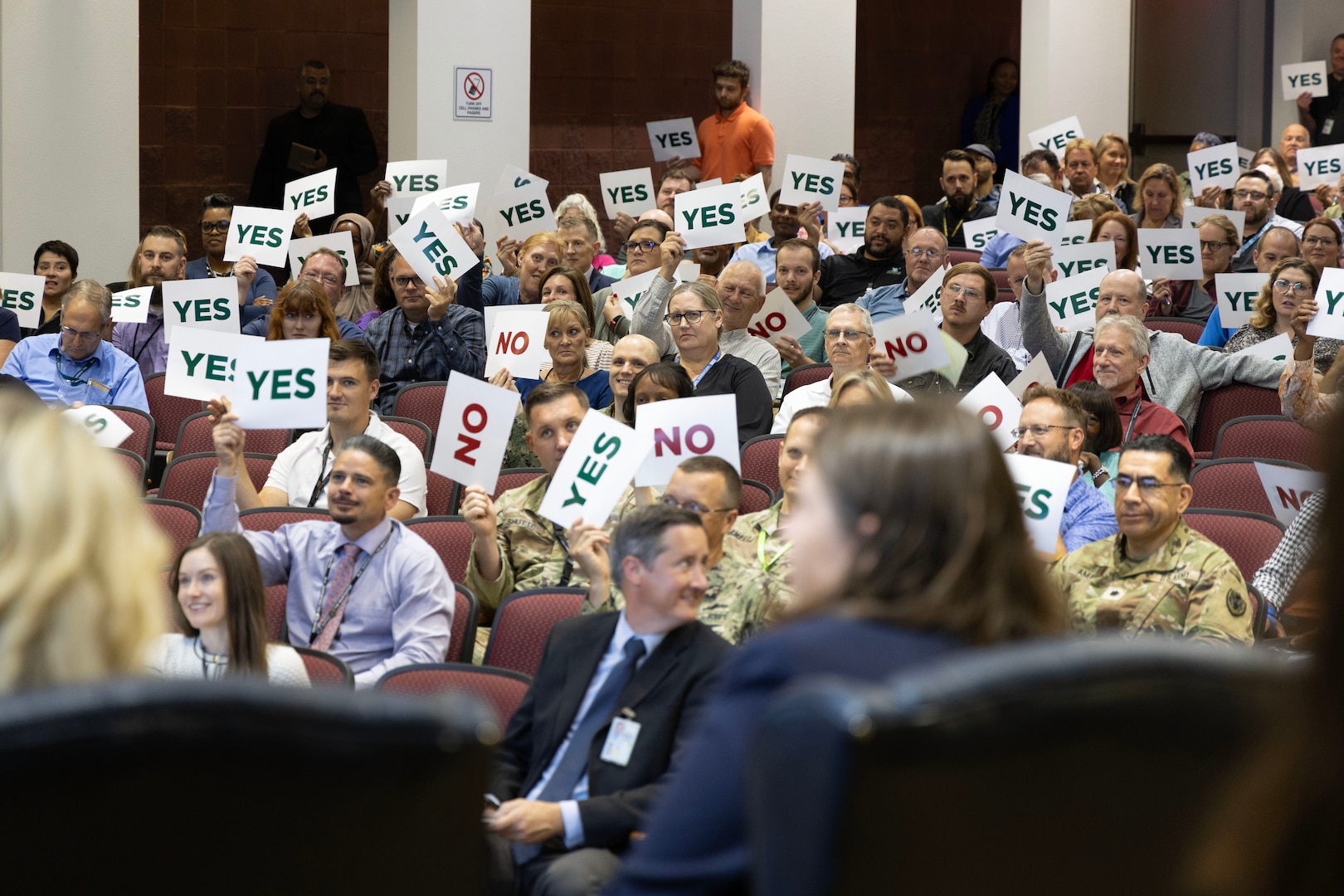 The crowd weighs in on a question in an auditorium.