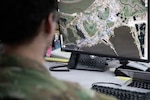 Tech. Sgt. Wolf Russo, Common Operating Picture manager with the Alaska National Guard’s Joint Force Headquarters, demonstrates capabilities of Maven in response to Western Alaska storms at Joint Base-Elmendorf Richardson, Alaska, Nov. 10, 2025. Maven improves communication with joint partners and enhances the COP while tracking supplies and personnel by integrating collected data from SHOUT Nanos. Photo by Azavyon McFarland.