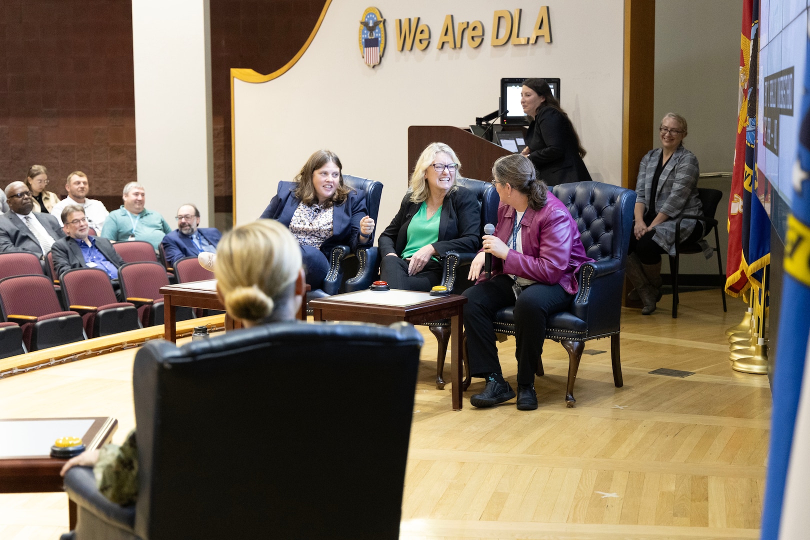 The contestants discuss a question during a mock Jeopardy game.