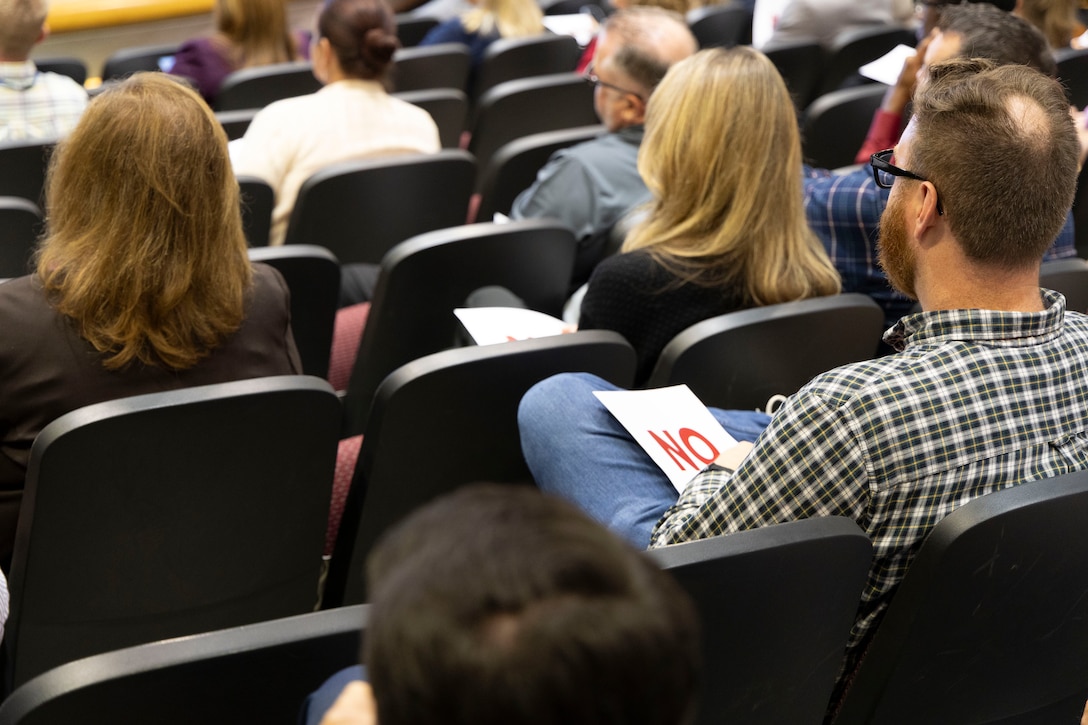 The audience takes notes.