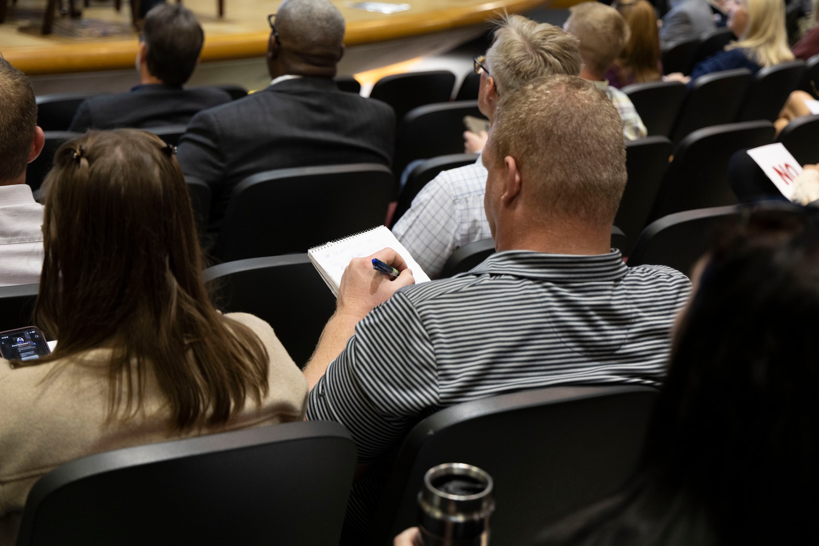 The audience takes notes.