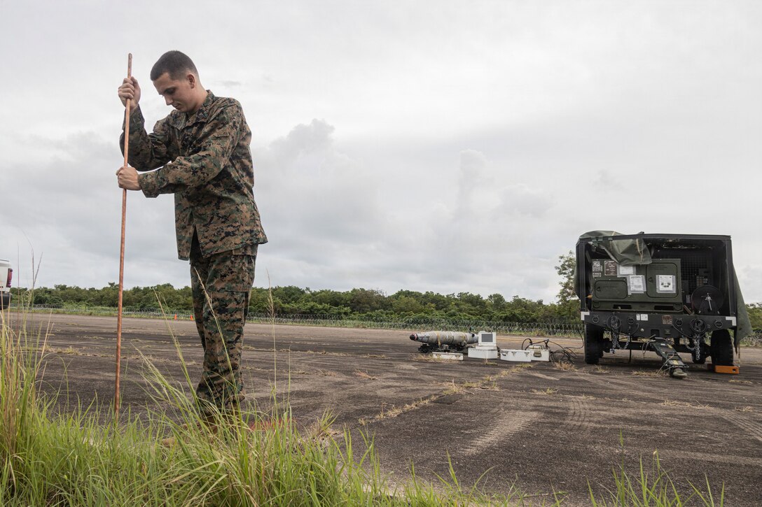 A U.S. Marine with Marine Fighter Attack Squadron (VMFA) 225, U.S. Marine Corps Forces, South, installs a grounding rod before operating a Common Munitions Bit Reprogramming Equipment system at Jose Aponte de la Torre Airport, Puerto Rico, Oct. 25, 2025. U.S. military forces are deployed to the Caribbean in support of the U.S. Southern Command mission, Department of War-directed operations, and the president’s priorities to disrupt illicit drug trafficking and protect the homeland. (U.S. Marine Corps photo)