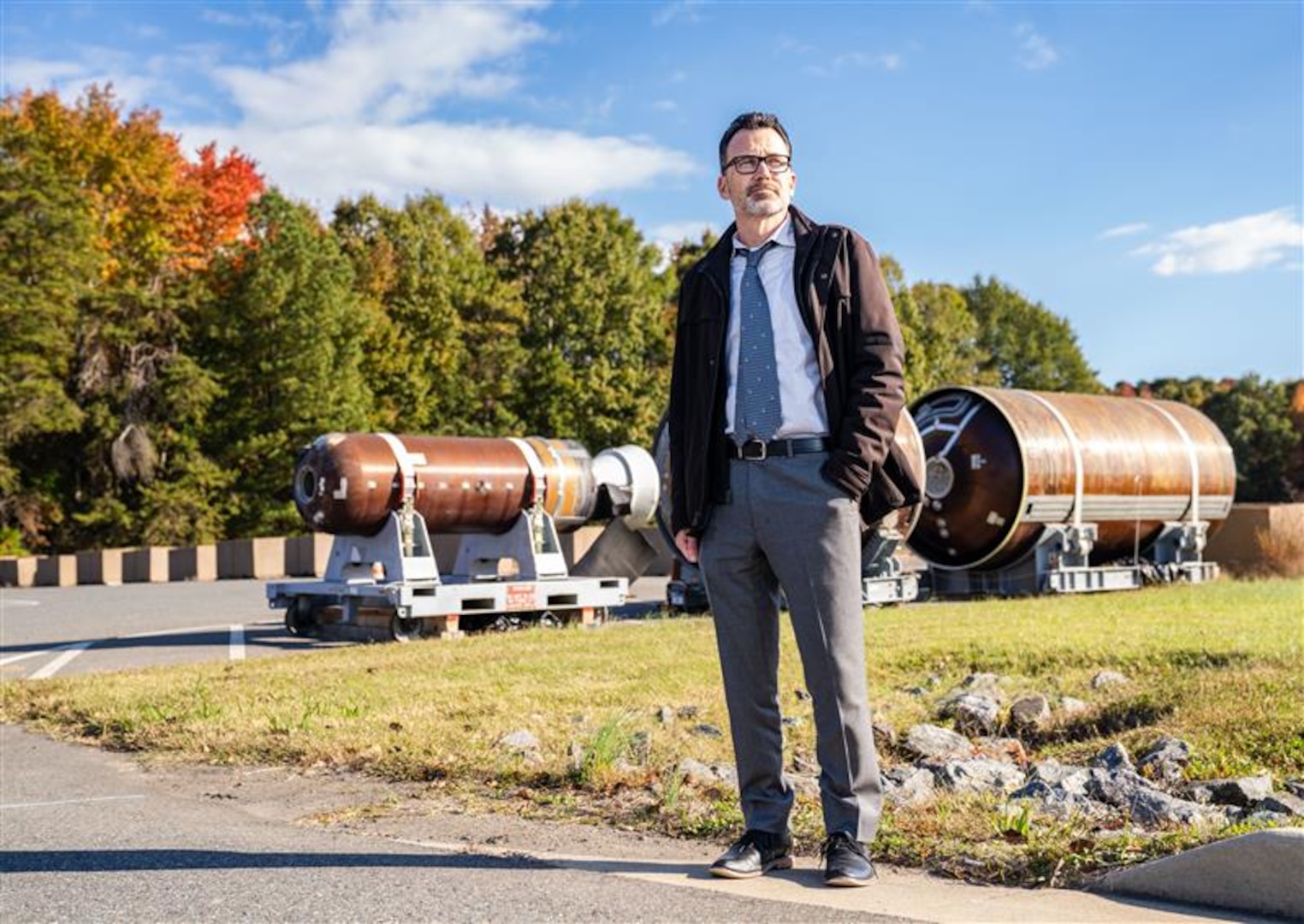 DAHLGREN, Va. – Dan Hogan, a scientist at Naval Surface Warfare Center Dahlgren Division, stands in front of the first, second and third stage motors of a submarine-launched ballistic missile. As a scientist at NSWCDD, he works on targeting and communications software for submarines, ensuring that these systems meet the needs of the Sailors who rely on them. (Dorina Watermolen/NSWCDD Photo)