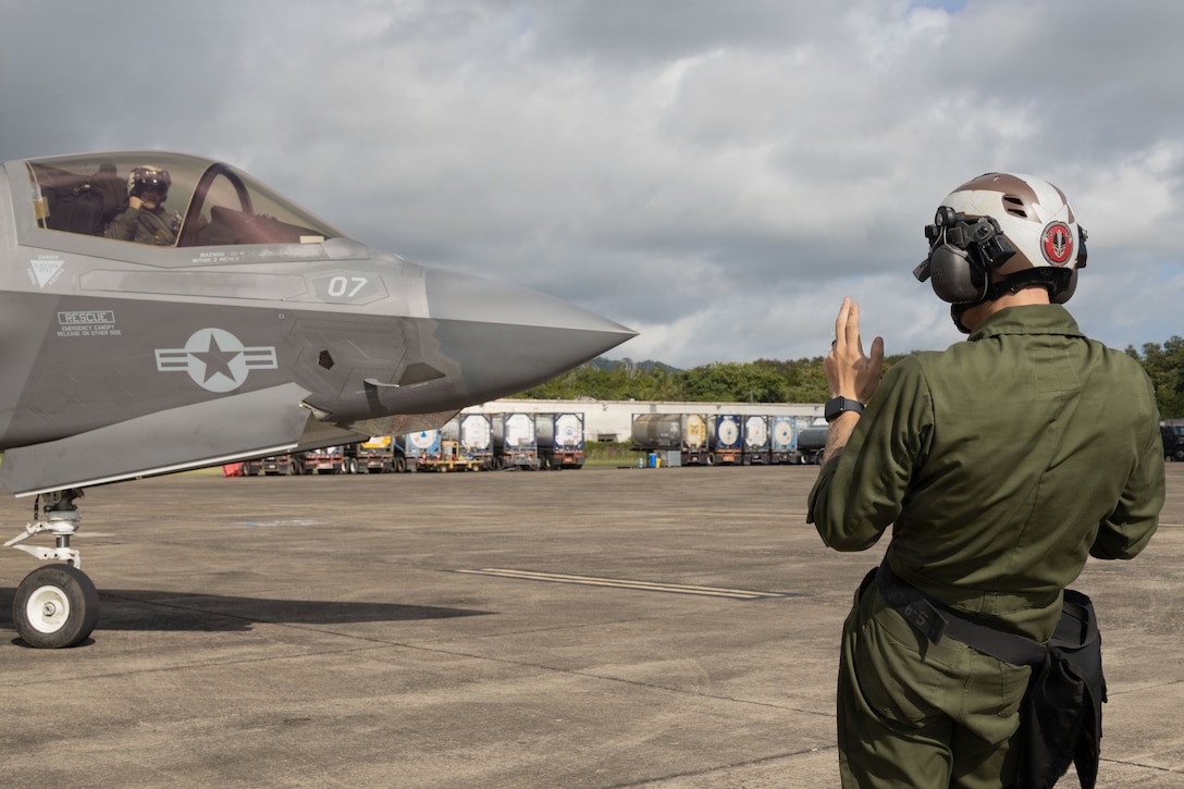 A U.S. Marine with Marine Fighter Attack Squadron (VMFA) 225, U.S. Marine Corps Forces, South, signals to an F-35B Lightning II assigned to VMFA-225 to begin taxiing at Jose Aponte de la Torre Airport in Ceiba, Puerto Rico, Oct. 29, 2025. U.S. military forces are deployed to the Caribbean in support of the U.S. Southern Command mission, Department of War-directed operations, and the president’s priorities to disrupt illicit drug trafficking and protect the homeland. (UU.S. Marine Corps photo)