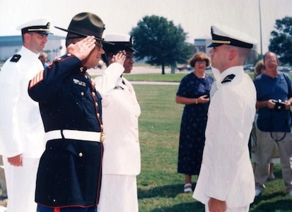 PENSACOLA, Fla. – Dan Hogan’s first salute marks the start of his commitment to service and leadership. After two decades in the Navy, Hogan now helps develop and enhance software that keeps the Navy’s submarines mission ready. (Dan Hogan/Courtesy Photo)