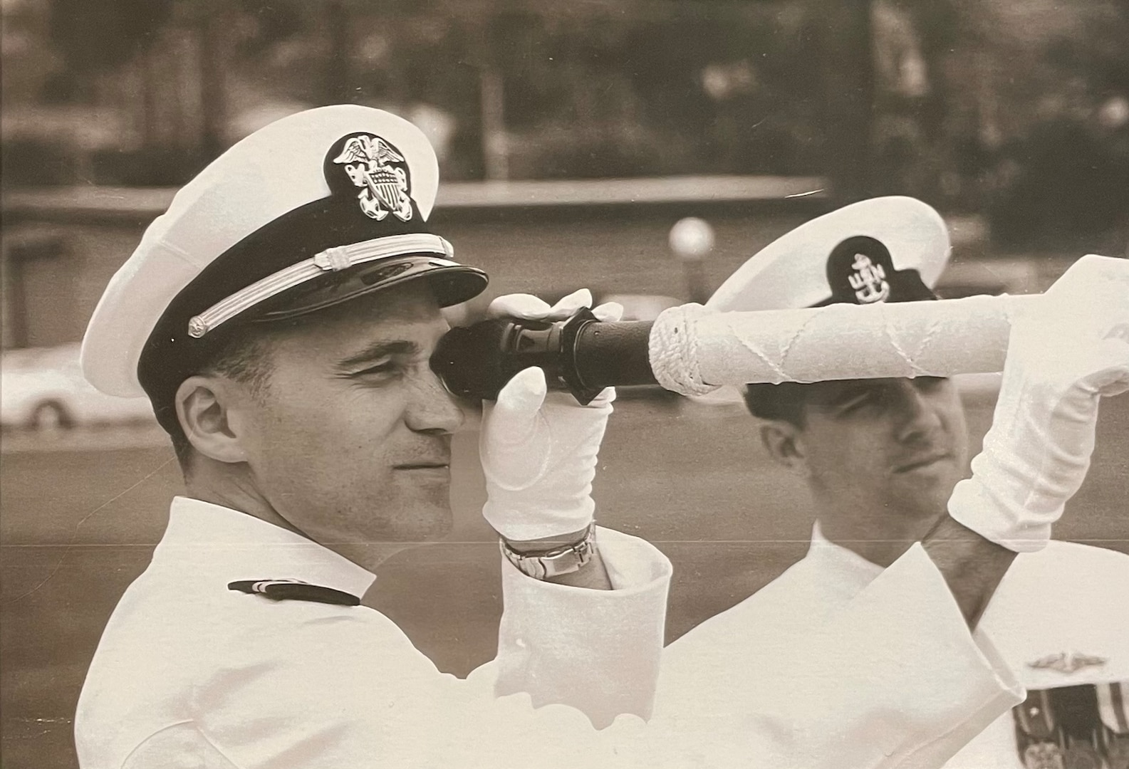 SAN DIEGO, Calif. – Dan Hogan holds a telescope during a change of command ceremony. Today, Hogan plays a crucial role in the development and enhancement of software that guarantees the submarines are always prepared for their missions. (Dan Hogan/Courtesy Photo)