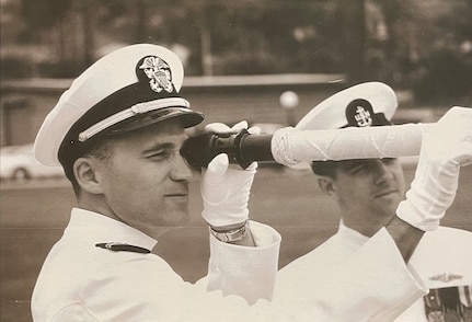 SAN DIEGO, Calif. – Dan Hogan holds a telescope during a change of command ceremony. Today, Hogan plays a crucial role in the development and enhancement of software that guarantees the submarines are always prepared for their missions. (Dan Hogan/Courtesy Photo)