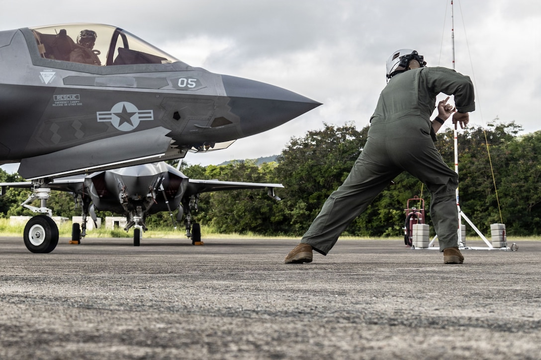 A U.S. Marine with Marine Fighter Attack Squadron (VMFA) 225, U.S. Marine Corps Forces, South, signals to a U.S. Marine Corps F-35B Lightning II assigned to VMFA-225 to begin taxiing at Jose Aponte de la Torre Airport in Ceiba, Puerto Rico, Oct. 29, 2025. U.S. military forces are deployed to the Caribbean in support of the U.S. Southern Command mission, Department of War-directed operations, and the president’s priorities to disrupt illicit drug trafficking and protect the homeland. (U.S. Marine Corps photo)