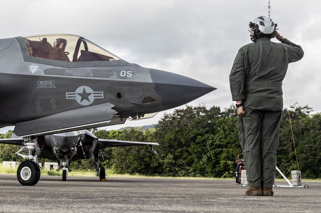 A U.S. Marine with Marine Fighter Attack Squadron (VMFA) 225, U.S. Marine Corps Forces, South, salutes a pilot in a U.S. Marine Corps F-35B Lightning II assigned to VMFA-225 at Jose Aponte de la Torre Airport in Ceiba, Puerto Rico, Oct. 29, 2025. U.S. military forces are deployed to the Caribbean in support of the U.S. Southern Command mission, Department of War-directed operations, and the president’s priorities to disrupt illicit drug trafficking and protect the homeland. (U.S. Marine Corps photo)