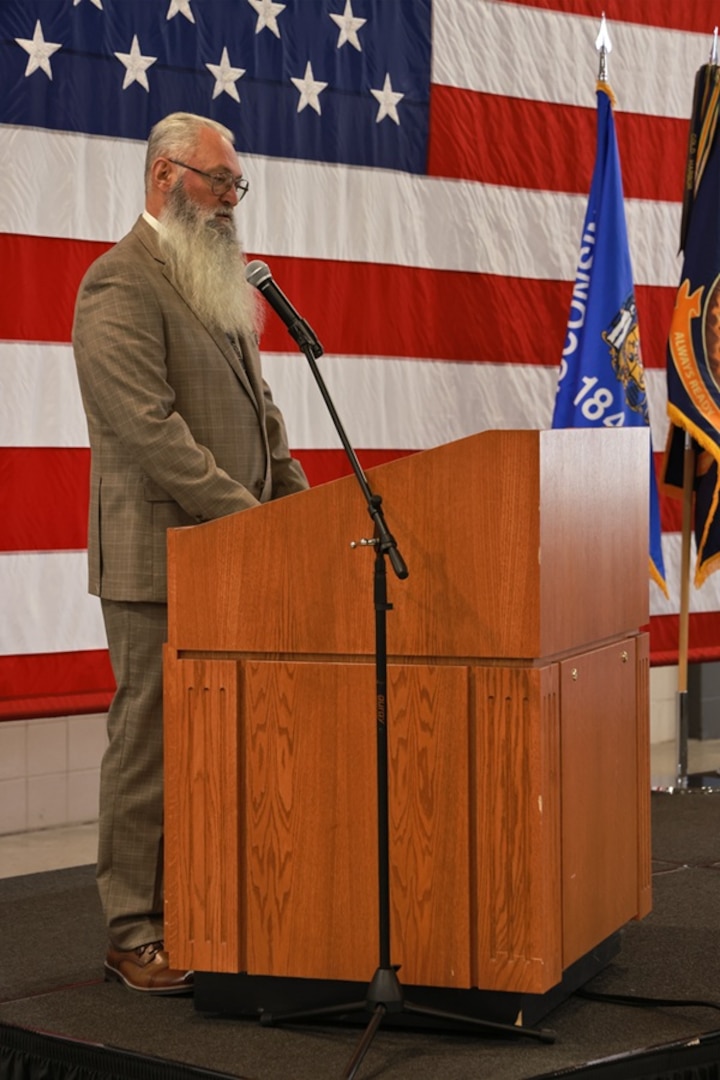 Retired U.S. Army Chief Warrant Officer 4 David Molitor addresses the audience following his induction into the Wisconsin Army National Guard Hall of Honor Nov. 1, 2025, at the Department of Military Affairs facility in Madison, Wisconsin. The Hall of Honor program was established in 2000 to recognize Wisconsin National Guard Soldiers who have distinguished themselves through exceptional achievement and devotion to duty, significantly contributing to the enduring legacy of the organization. (U.S. National Guard photo by Paul Gorman)