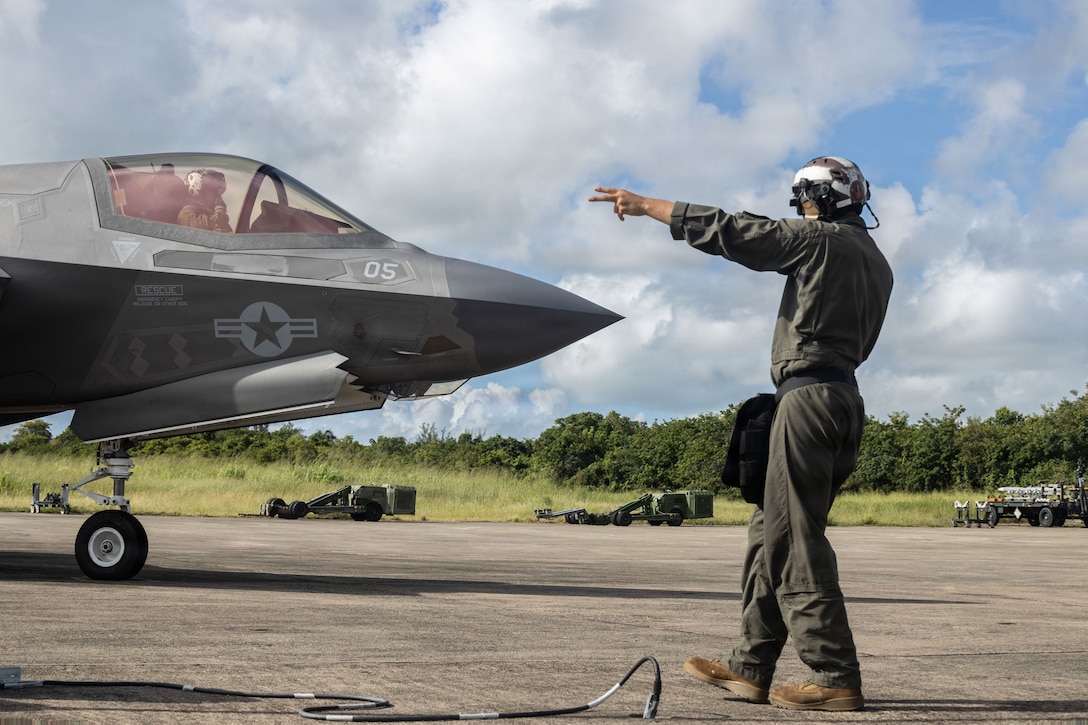 A U.S. Marine with Marine Fighter Attack Squadron (VMFA) 225, U.S. Marine Corps Forces, South, guides a U.S. Marine Corps F-35B Lightning II assigned to VMFA-225 during its taxi at Jose Aponte de la Torre Airport in Ceiba, Puerto Rico, Nov. 4, 2025. U.S. military forces are deployed to the Caribbean in support of the U.S. Southern Command mission, Department of War-directed operations, and the president’s priorities to disrupt illicit drug trafficking and protect the homeland. (U.S. Marine Corps photo)