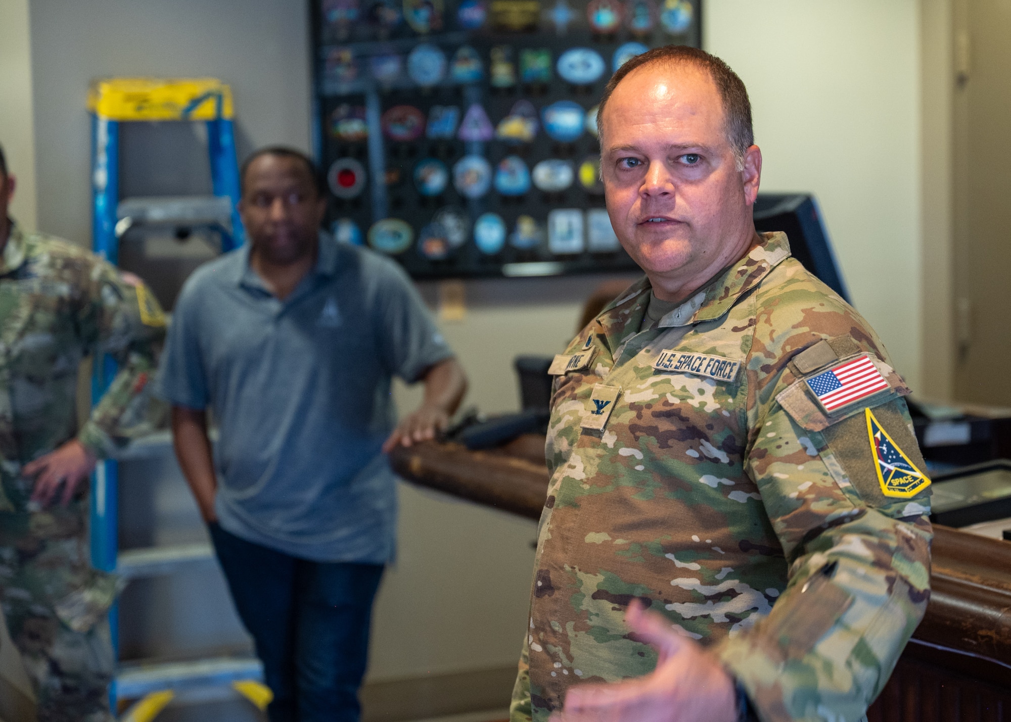 U.S. Space Force Col. James Horne III, Space Launch Delta 30 commander, stands, speaks, and motions to the crowd.
