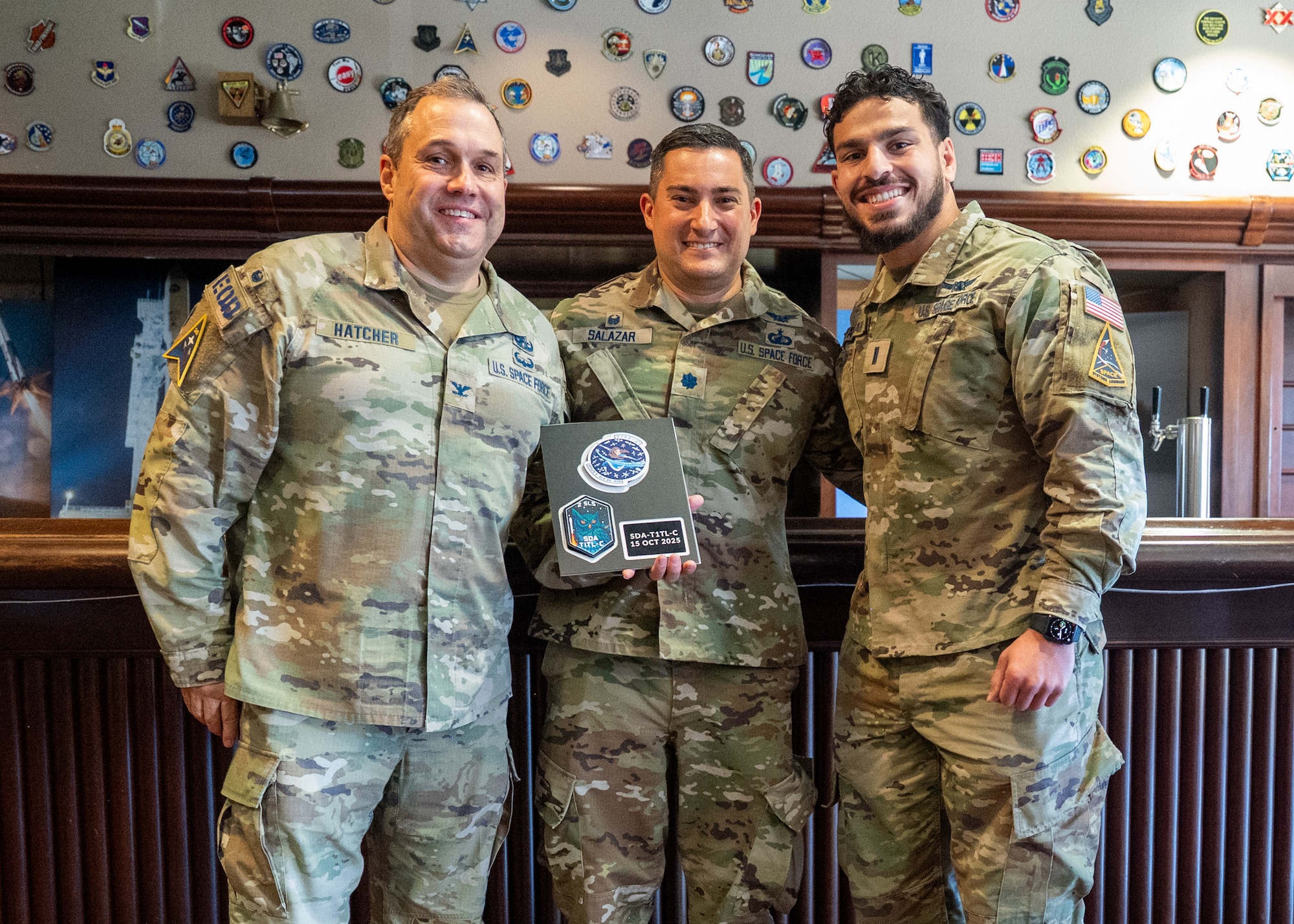 U.S. Space Force Col. Dorian Hatcher, Space Launch Delta 30 deputy commander, Lt. Col. Ralph Salazar, 2nd Range Operations Squadron commander, and 1st Lt. Omar Fattah stand and smile.