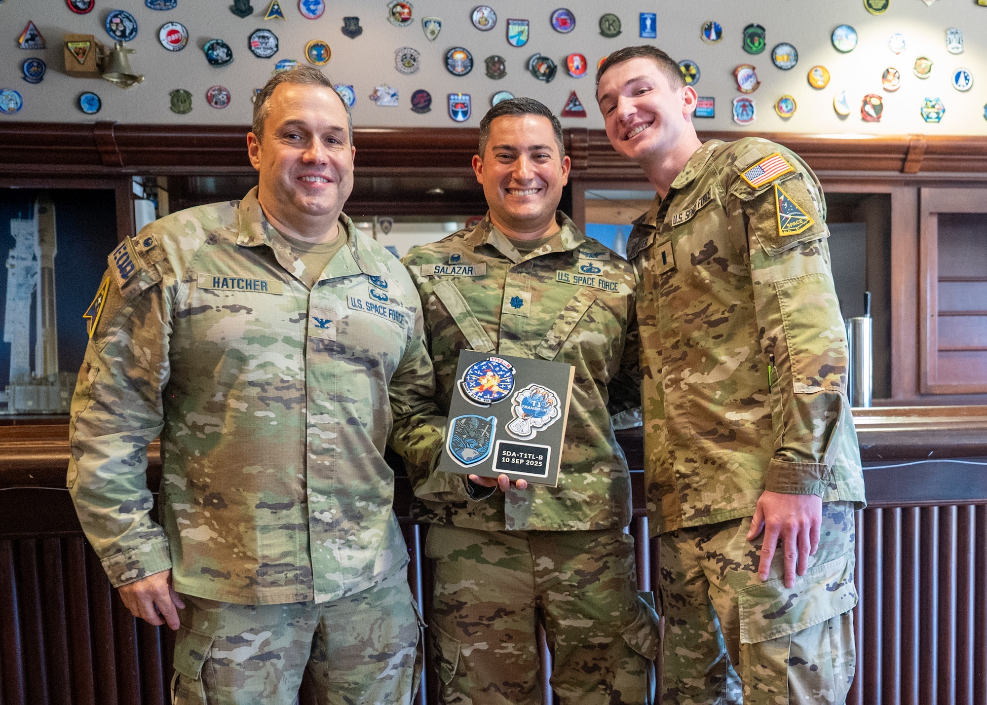 U.S. Space Force Col. Dorian Hatcher, Space Launch Delta 30 deputy commander, Lt. Col. Ralph Salazar, 2nd Range Operations Squadron commander, and 1st Lt. Pavel Buechter, stand and smile.