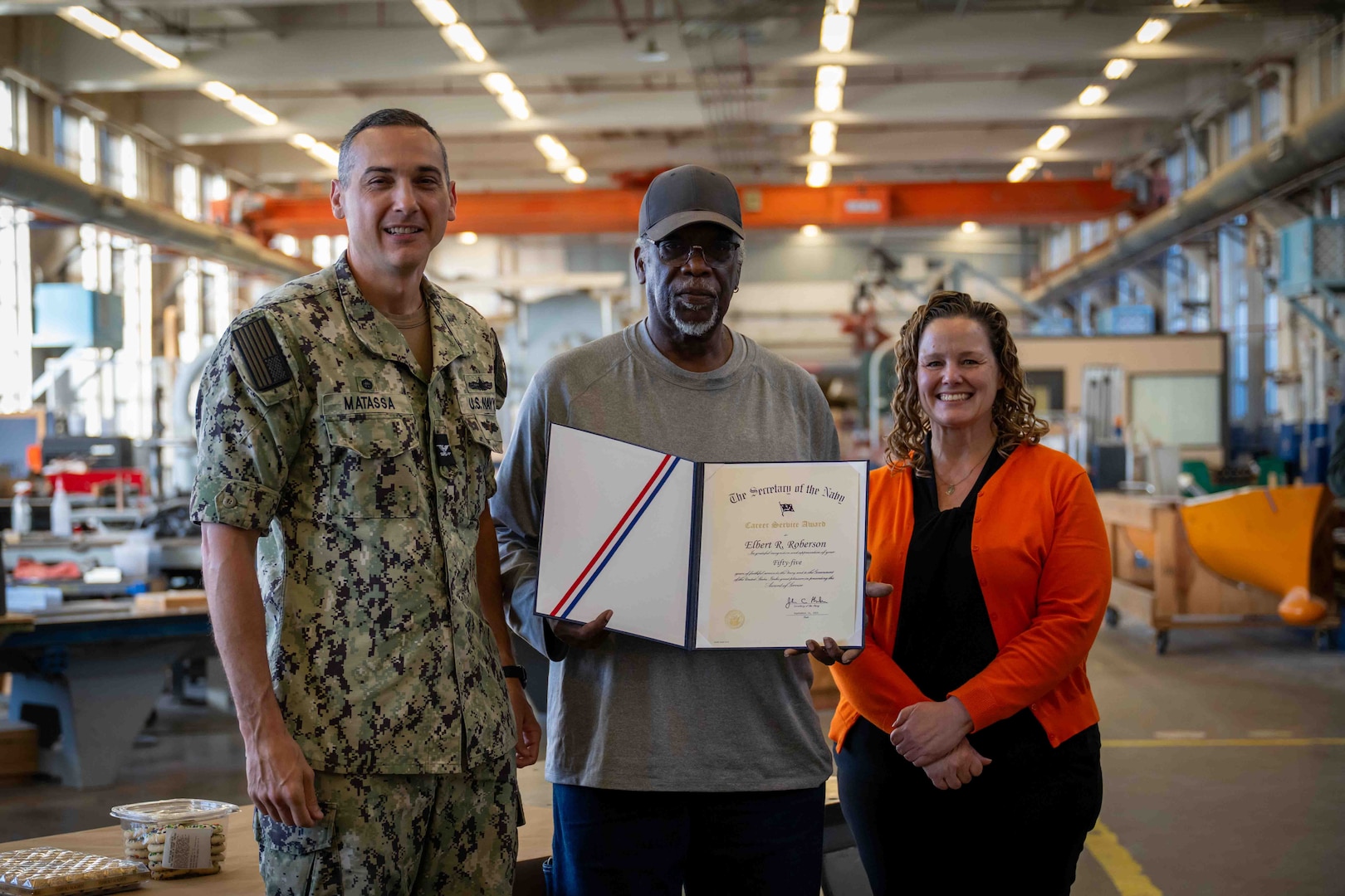 Carderock Modelmaker Technician Elbert Roberson (middle) posing with Carderock’s Commanding Officer Capt. Chris Matassa (left) and acting Technical Director Kate Terwilliger (right) after receiving his award for 55 years of service.