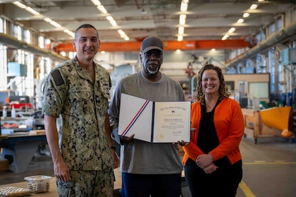 Carderock Modelmaker Technician Elbert Roberson (middle) posing with Carderock’s Commanding Officer Capt. Chris Matassa (left) and acting Technical Director Kate Terwilliger (right) after receiving his award for 55 years of service.