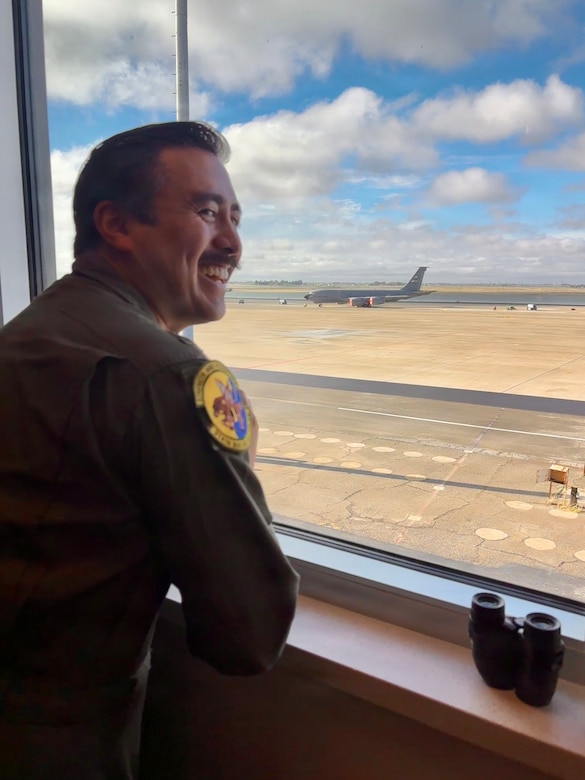 An airman looks out toward the flightline from an operations office inside the new Squadron Operations and Aircraft Maintenance Unit facility at Beale Air Force Base, California on Nov. 14, 2025.