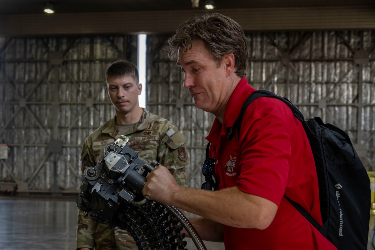 A member of the Wenatchee Valley sister city delegation lifts an F-16 Fighting Falcon component at Misawa Air Base, Japan, Oct. 3, 2025. The visit strengthened the long-standing sister-city partnership between Wenatchee Valley and Misawa, reinforcing community bonds that support U.S.–Japan cooperation in northern Japan. (U.S. Air Force photo by Senior Airman Patrick Boyle)