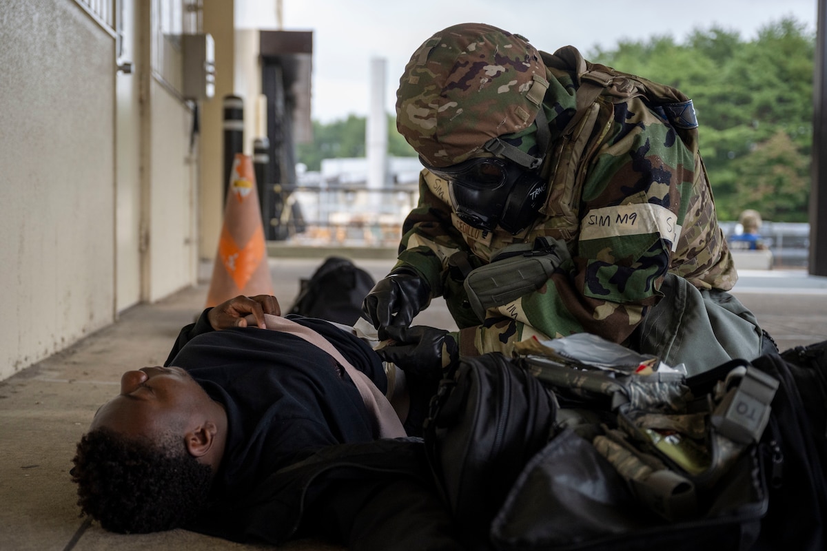 A U.S. Air Force Airman assigned to the 35th Logistics Readiness Squadron simulates treating a casualty actor during a post attack reconnaissance sweep during Beverly Sunrise 26-01 at Misawa Air Base, Japan, Oct. 16, 2025. Training under realistic combat conditions enhanced crisis response proficiency, enabling Airmen to operate effectively in degraded or contested environments. (U.S. Air Force photo by Senior Airman Patrick Boyle)