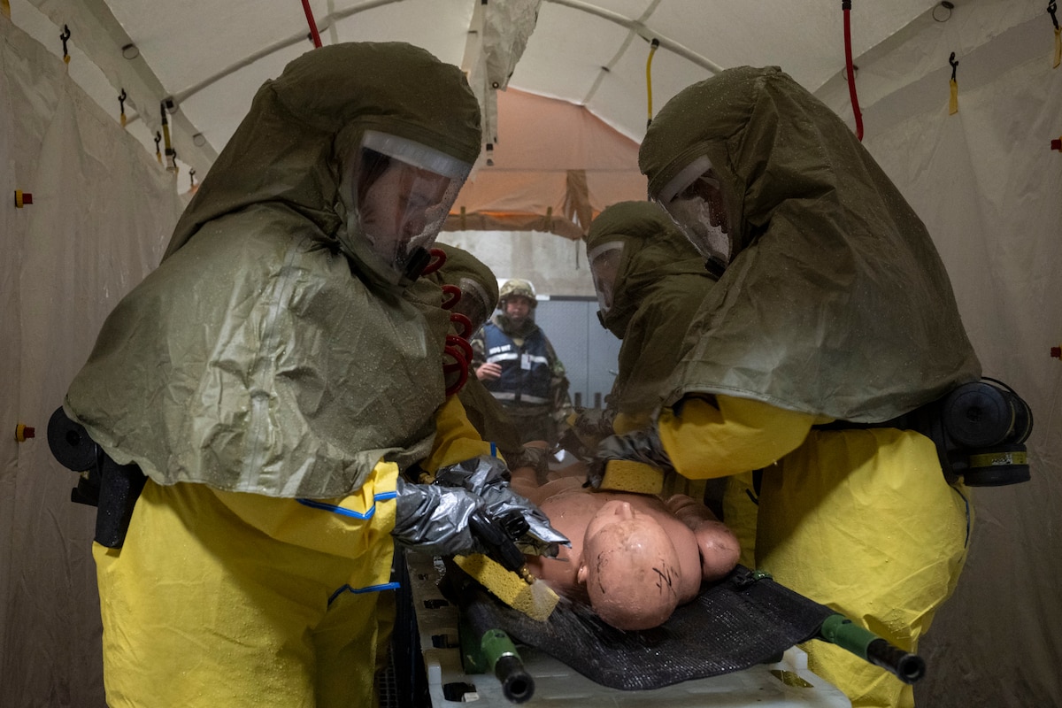 U.S. Air Force Airmen assigned to the 35th Medical Group simulate decontaminating a patient during Beverly Sunrise 26-01 at Misawa Air Base, Japan, Oct. 16, 2025. Practicing rapid casualty care and recovery advanced the wing’s ability to maintain combat readiness and resilience during dynamic operational scenarios. (U.S. Air Force photo by Senior Airman Patrick Boyle)