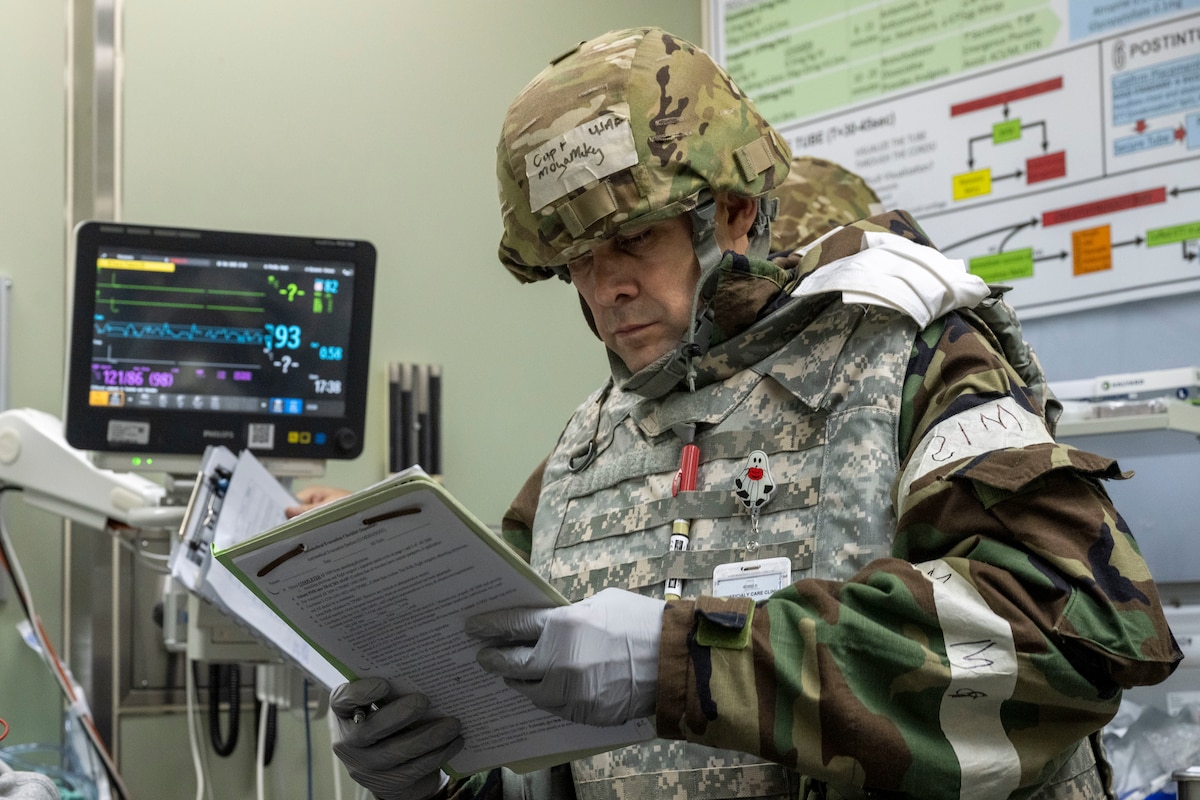 A U.S. Air Force Airman assigned to the 35th Medical Group examines notes during Beverly Sunrise 26-01 at Misawa Air Base, Japan, Oct. 16, 2025. The exercise demonstrated the 35th Fighter Wing’s commitment to readiness and reinforced its role in supporting regional stability and security through sustained operational capability. (U.S. Air Force photo by Senior Airman Patrick Boyle)