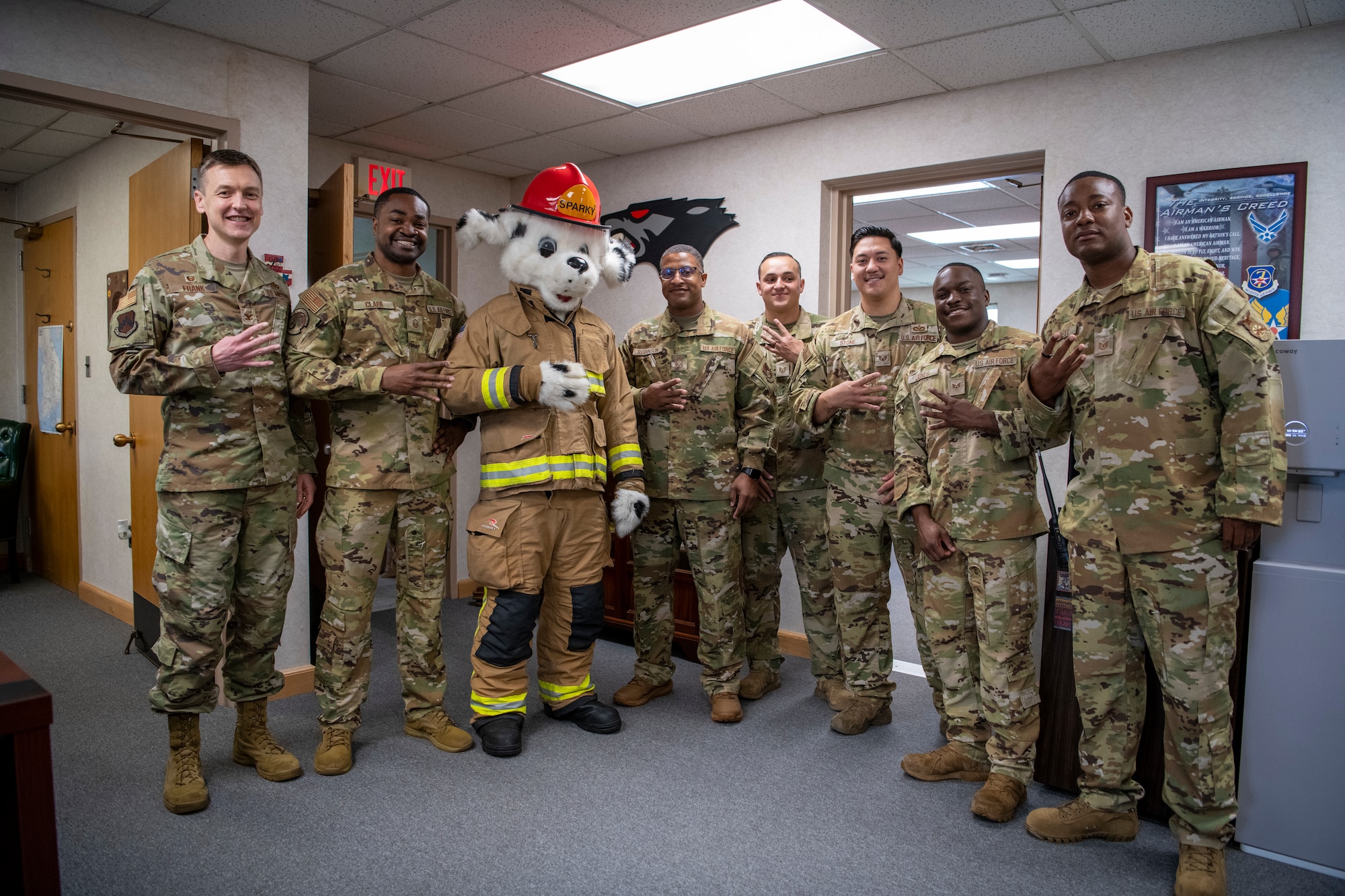 A mascot poses with a group of people.