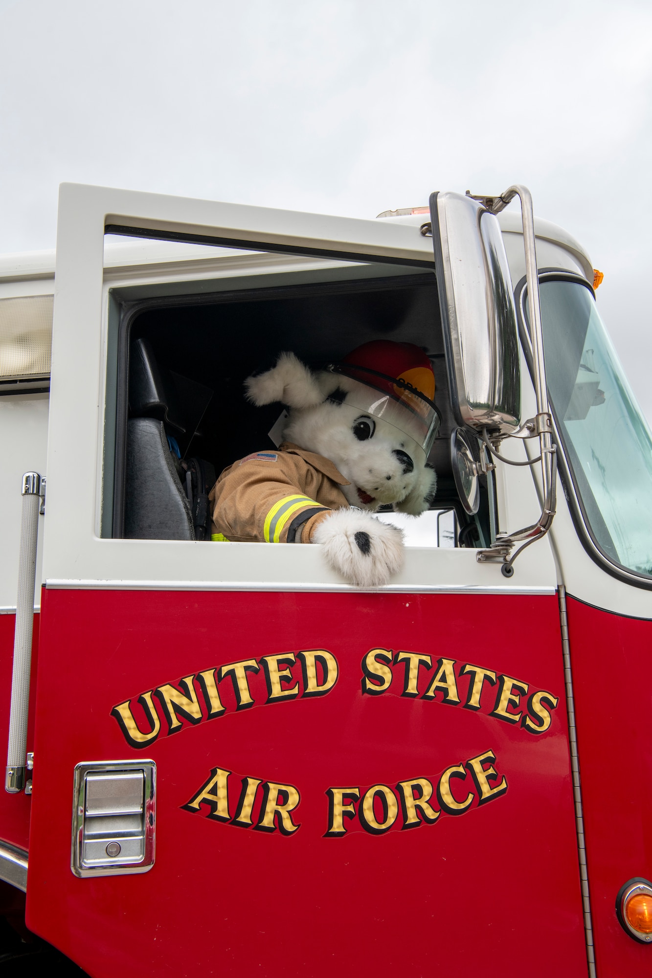 A mascot enters a fire truck.