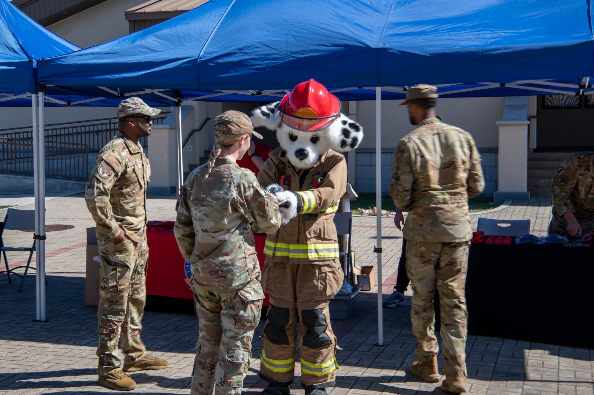 A mascot greets people.