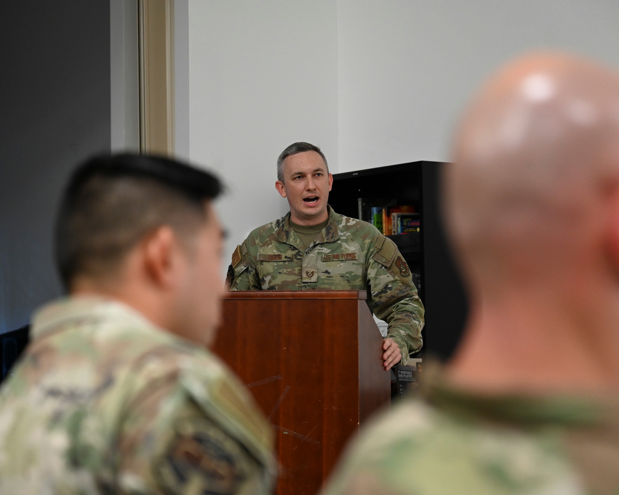U.S. Air Force Tech. Sgt. John Drum, 644th Combat Communications Squadron training noncommissioned officer in charge, gives remarks during the Expeditionary Communications Course Graduation at Andersen Air Force Base, Guam, Oct. 3, 2025.