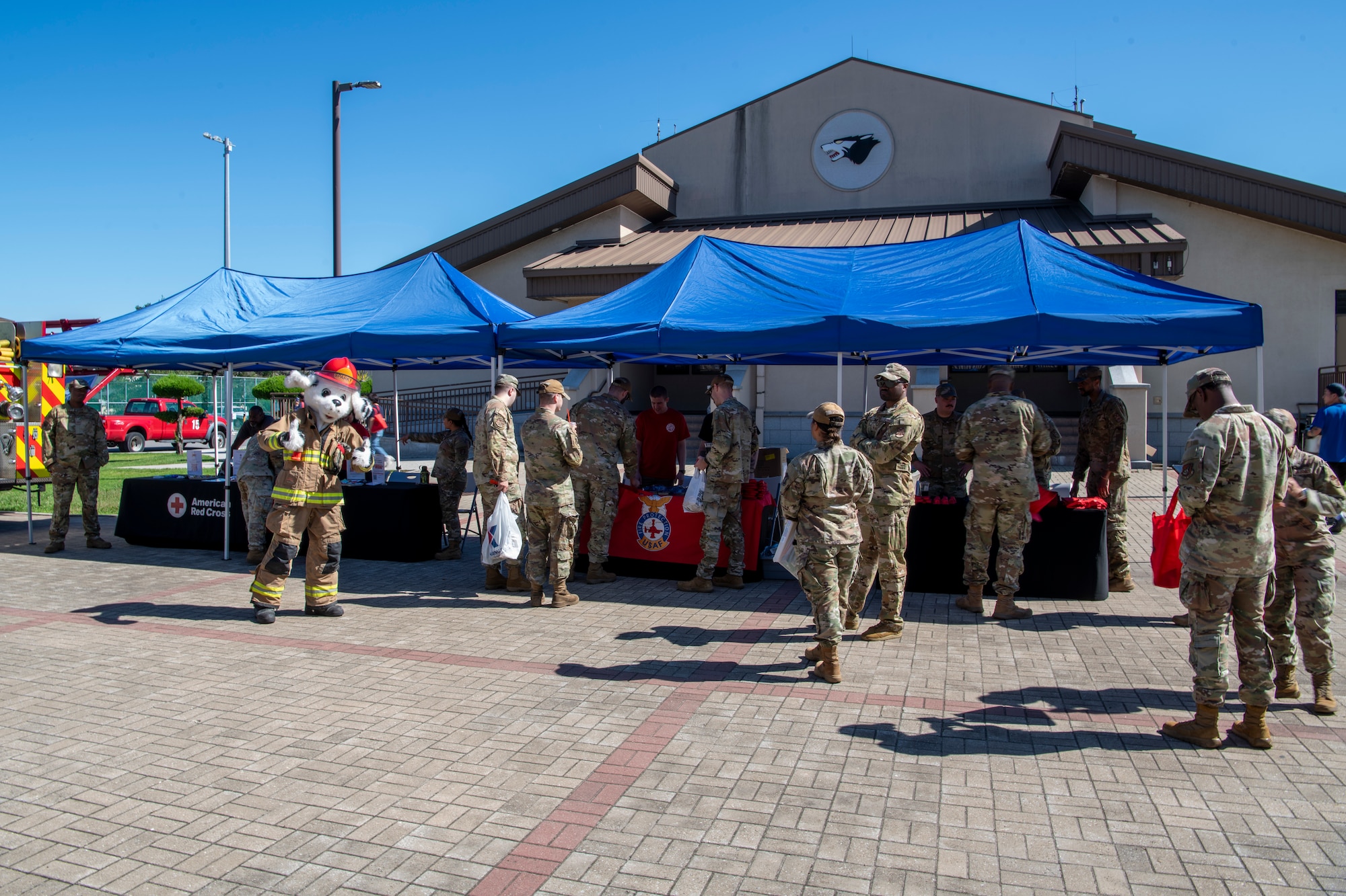 People stand around a booth.