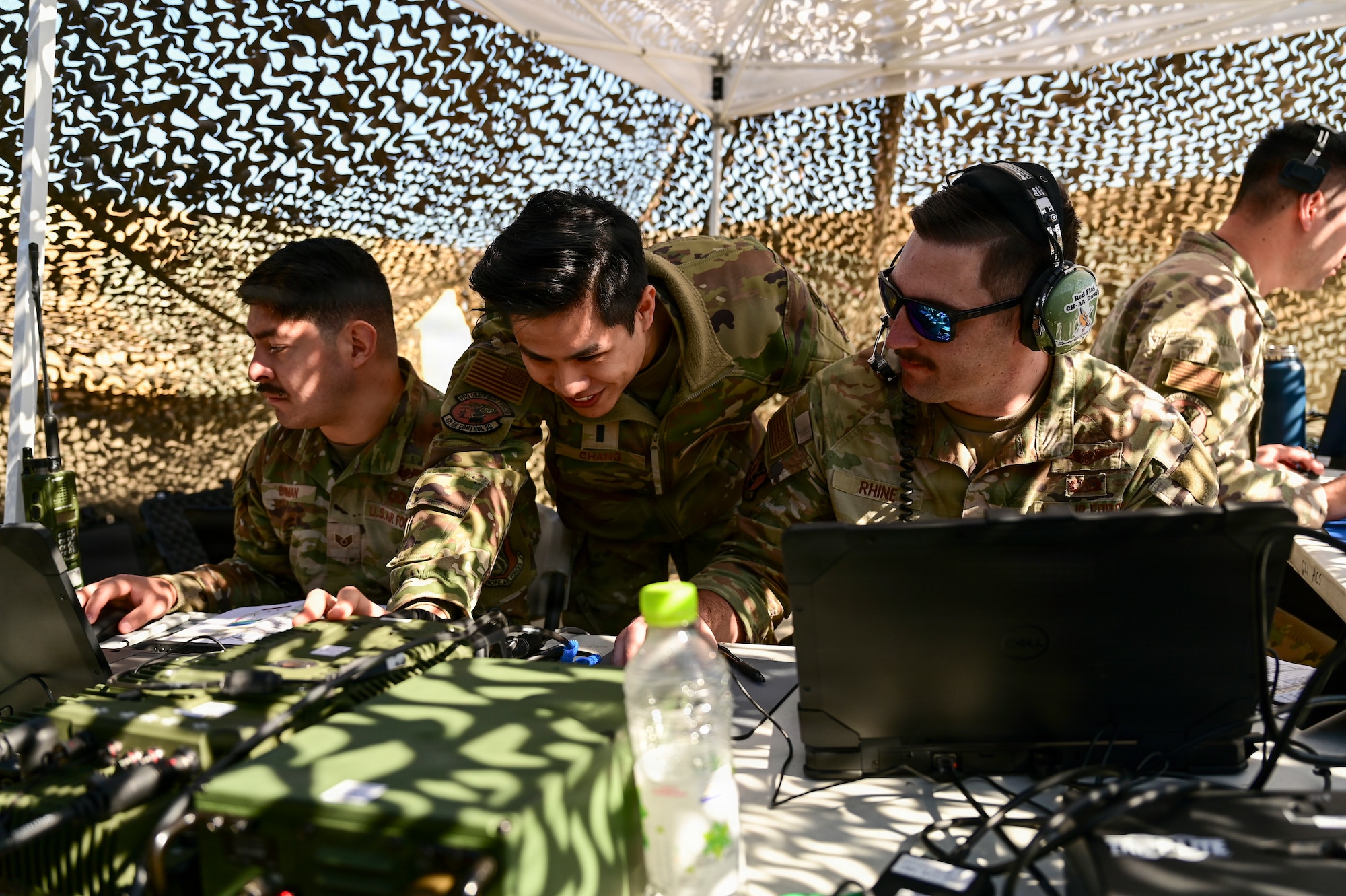 A group of men work in a tent.