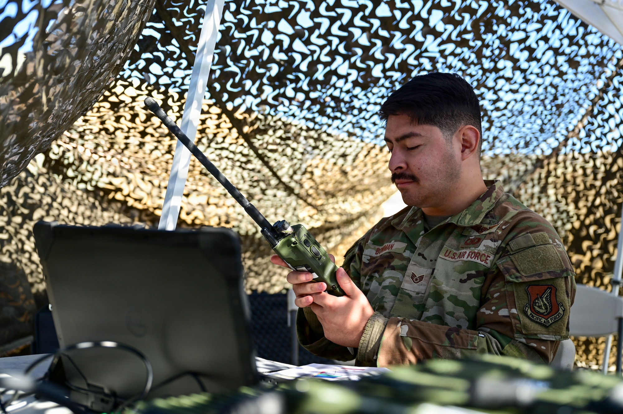 A man operates a radio.