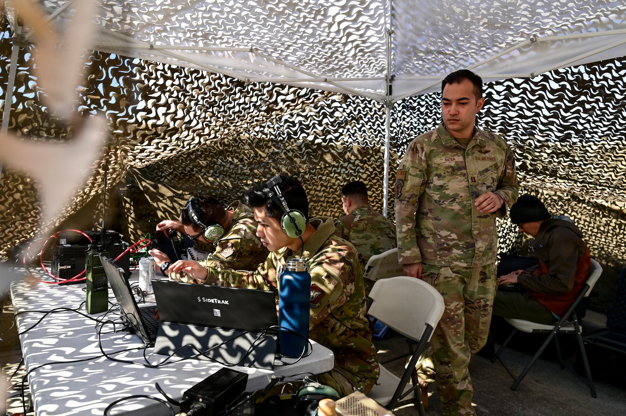 A group works in a tent.