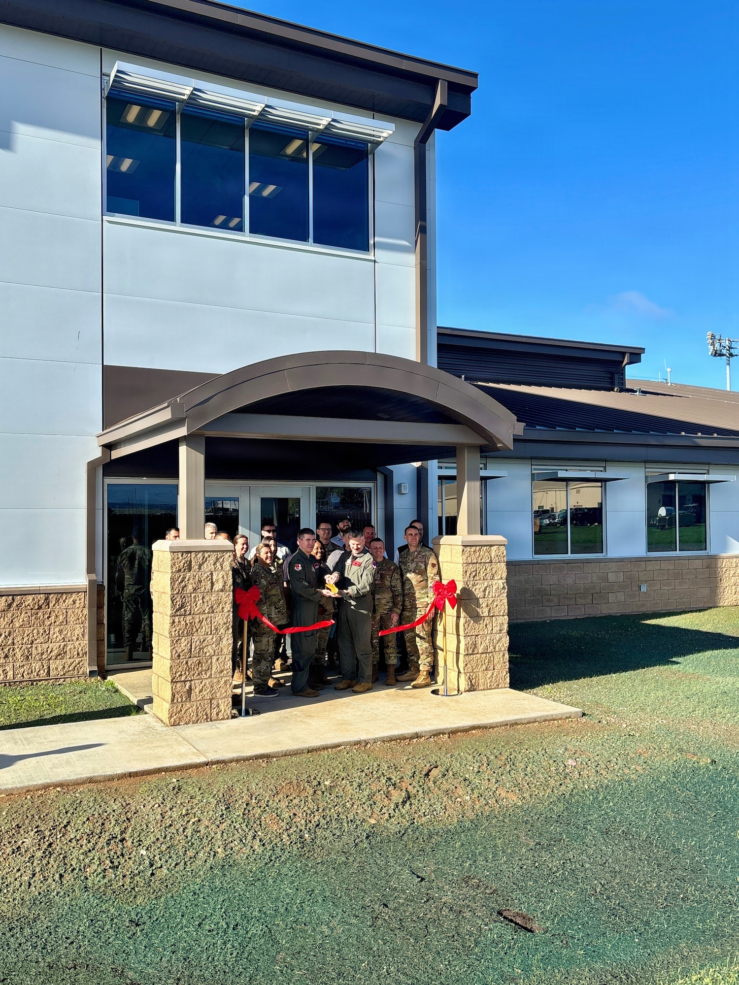 Leaders from the 940th Air Refueling Wing join U.S. Army Corps of Engineers Sacramento District representatives for a ribbon cutting celebrating the completion of the new Squadron Operations and Aircraft Maintenance Unit facility at Beale Air Force Base on Nov. 14, 2025.