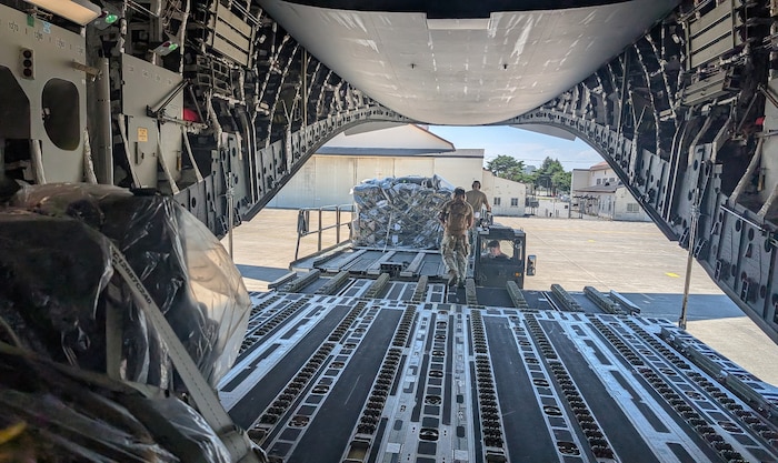 Airmen with the 752nd Operations Support Squadron unload the Tactical Operations Center – Light kit from a U.S. aircraft here, July 25, 2025. The TOC-L is a mobile, scalable node that fuses data from multiple sources to build a synchronized air picture, enabling faster and more accurate decision-making. Its development supports the evolving DAF BATTLE NETWORK, which connects sensors, effectors, and logistics systems across domains. (Courtesy Photo)