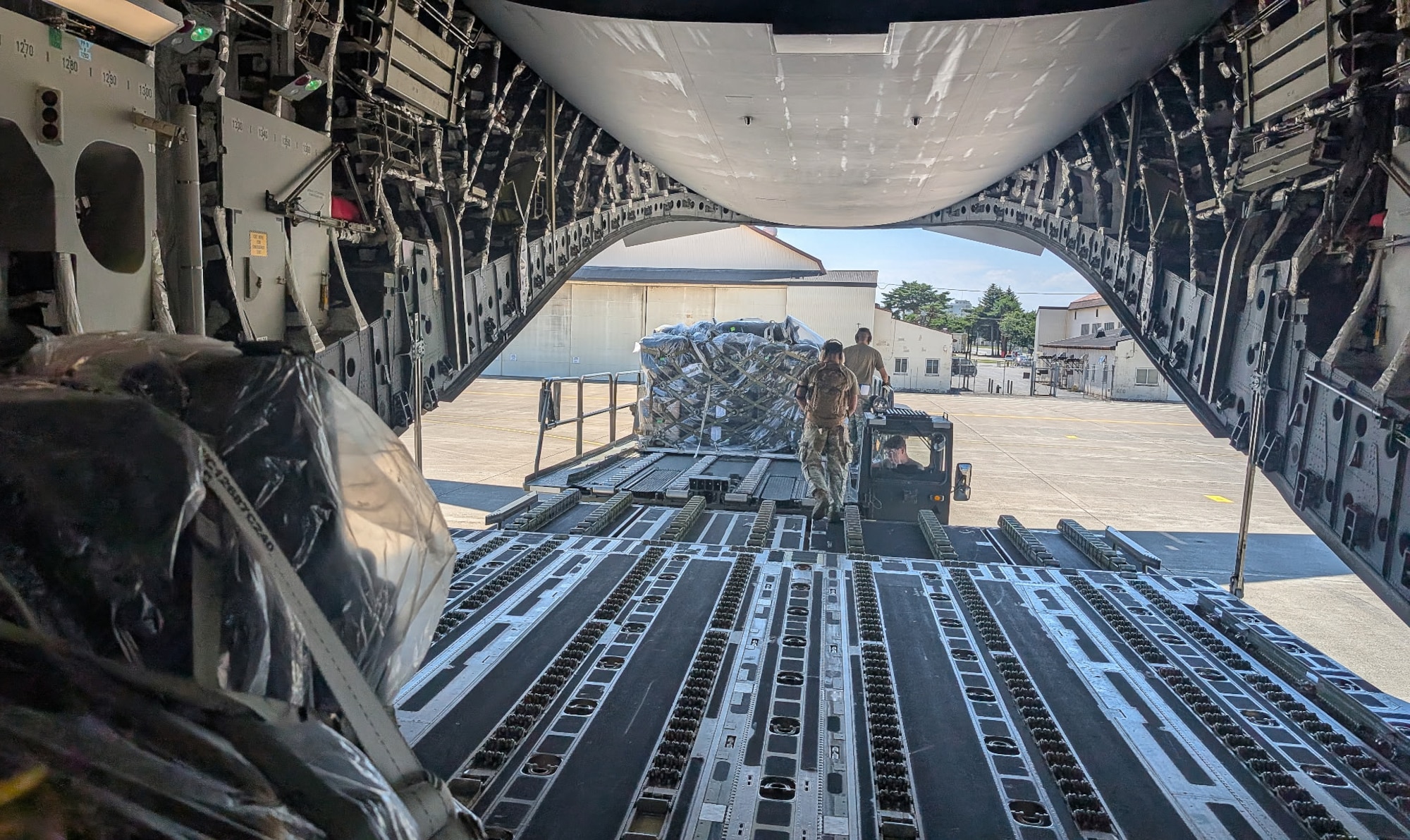 Airmen with the 752nd Operations Support Squadron unload the Tactical Operations Center – Light kit from a U.S. aircraft here, July 25, 2025. The TOC-L is a mobile, scalable node that fuses data from multiple sources to build a synchronized air picture, enabling faster and more accurate decision-making. Its development supports the evolving DAF BATTLE NETWORK, which connects sensors, effectors, and logistics systems across domains. (Courtesy Photo)