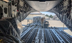 Airmen with the 752nd Operations Support Squadron unload the Tactical Operations Center – Light kit from a U.S. aircraft here, July 25, 2025. The TOC-L is a mobile, scalable node that fuses data from multiple sources to build a synchronized air picture, enabling faster and more accurate decision-making. Its development supports the evolving DAF BATTLE NETWORK, which connects sensors, effectors, and logistics systems across domains. (Courtesy Photo)
