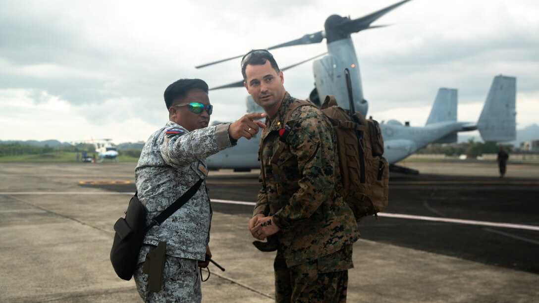 A Philippine Air Force service member, left, coordinates with U.S. Marine Corps Maj. Steve Lundin, right,  the officer in charge of the Humanitarian Assistance Response Team assigned to Marine Rotational Force-Southeast Asia, I Marine Expeditionary Force, about unloading palletized family food packs from a U.S. Marine Corps MV-22B Osprey attached to Marine Medium Tiltrotor Squadron (VMM) 262, Marine Aircraft Group 36, 1st Marine Aircraft Wing, in support of foreign disaster relief operations at Virac, Philippines, Nov. 13, 2025. At the request of the Government of the Philippines, the U.S. military is working alongside the Armed Forces of the Philippines to provide foreign disaster relief support to communities affected by consecutive Typhoons Kalmaegi (Tino) and Fung-Wong (Uwan), which caused extensive damage and tragic loss of life. The forward presence and ready posture of United States Indo-Pacific Command in the region facilitates rapid and effective response to crisis, demonstrating the U.S.’s commitment to Allies and partners during times of need.  (U.S. Marine Corps photo by Cpl. Brian Knowles)