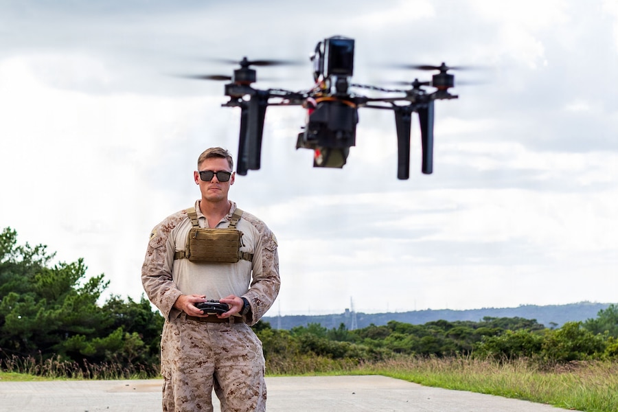U.S. Marine Corps Cpl. Greg Samarin, a radio operator with Expeditionary Operations Training Group, III Marine Expeditionary Force, flies a drone equipped with an M67 training grenade during an Unmanned Aircraft Systems course demonstration at Camp Hansen, Okinawa, Japan, Nov. 6, 2025.