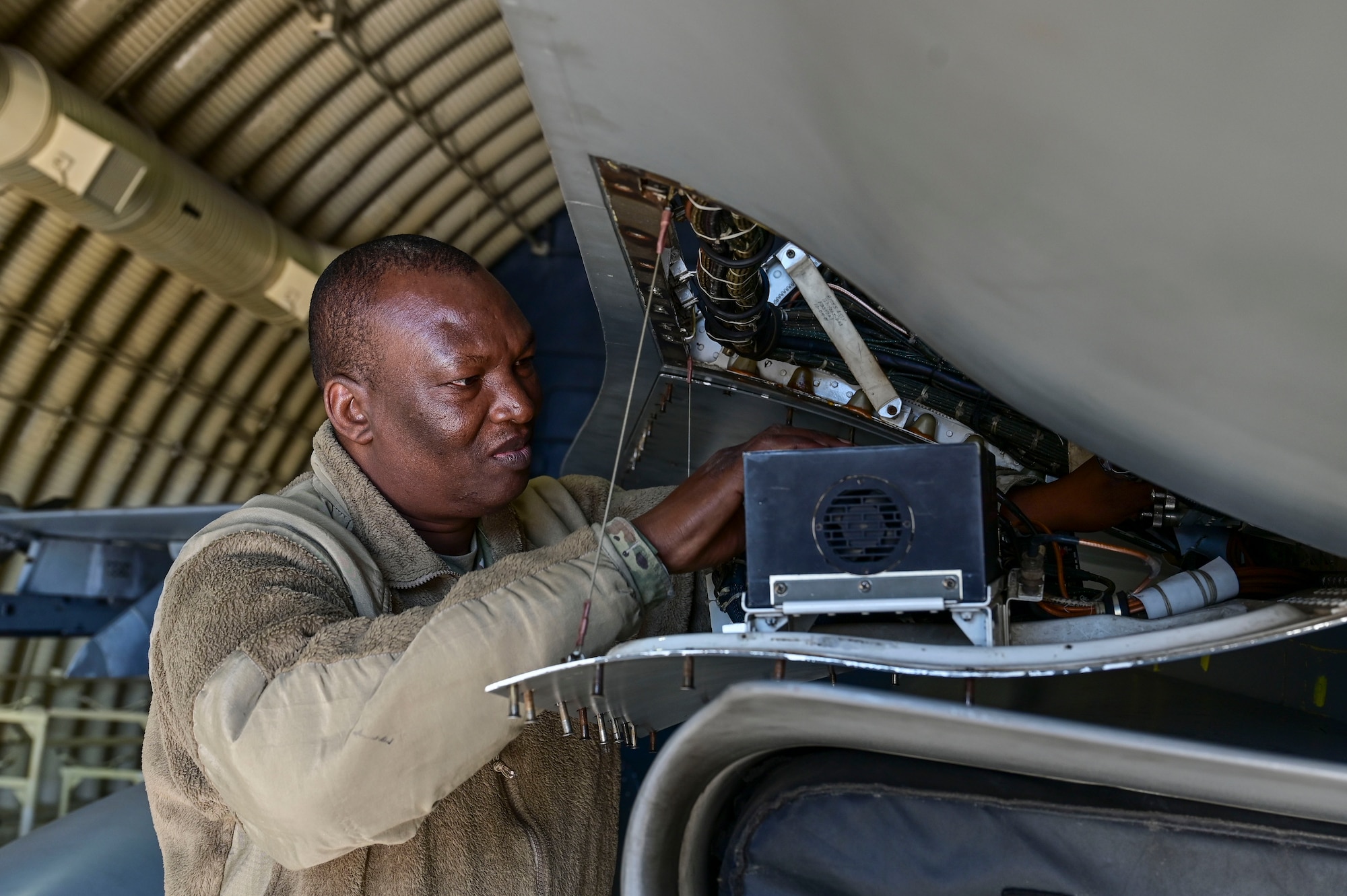 A man inspects an aircraft part.