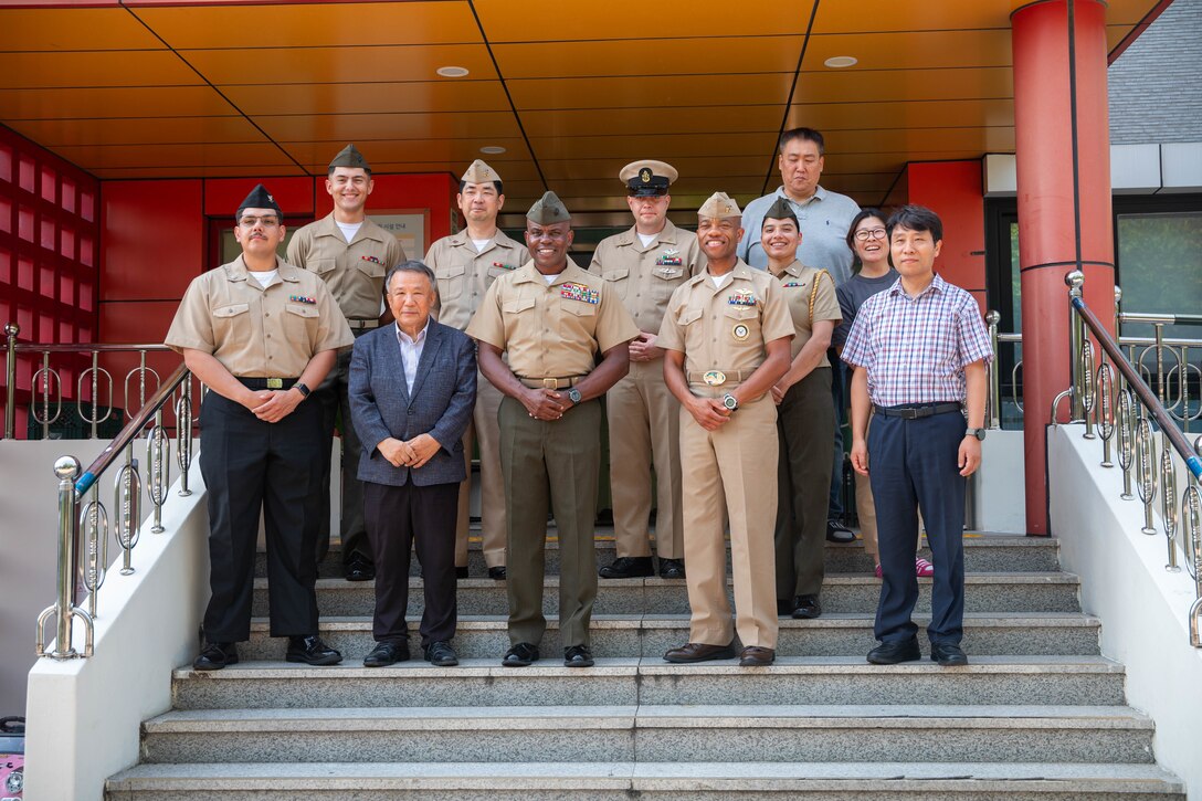 U.S. Marines, Sailors, and staff from the Sunrin Aeyukwon Children’s Home pose for a photo in Pohang, South Korea, Aug. 22, 2025. Marines and the children’s home have maintained a strong relationship since the facility was established in 1952 with the help of 1st Marine Aircraft Wing and Naval Construction Battalion Maintenance Unit 101. (U.S. Marine Corps photo by Cpl. Jeremiah Barksdale)