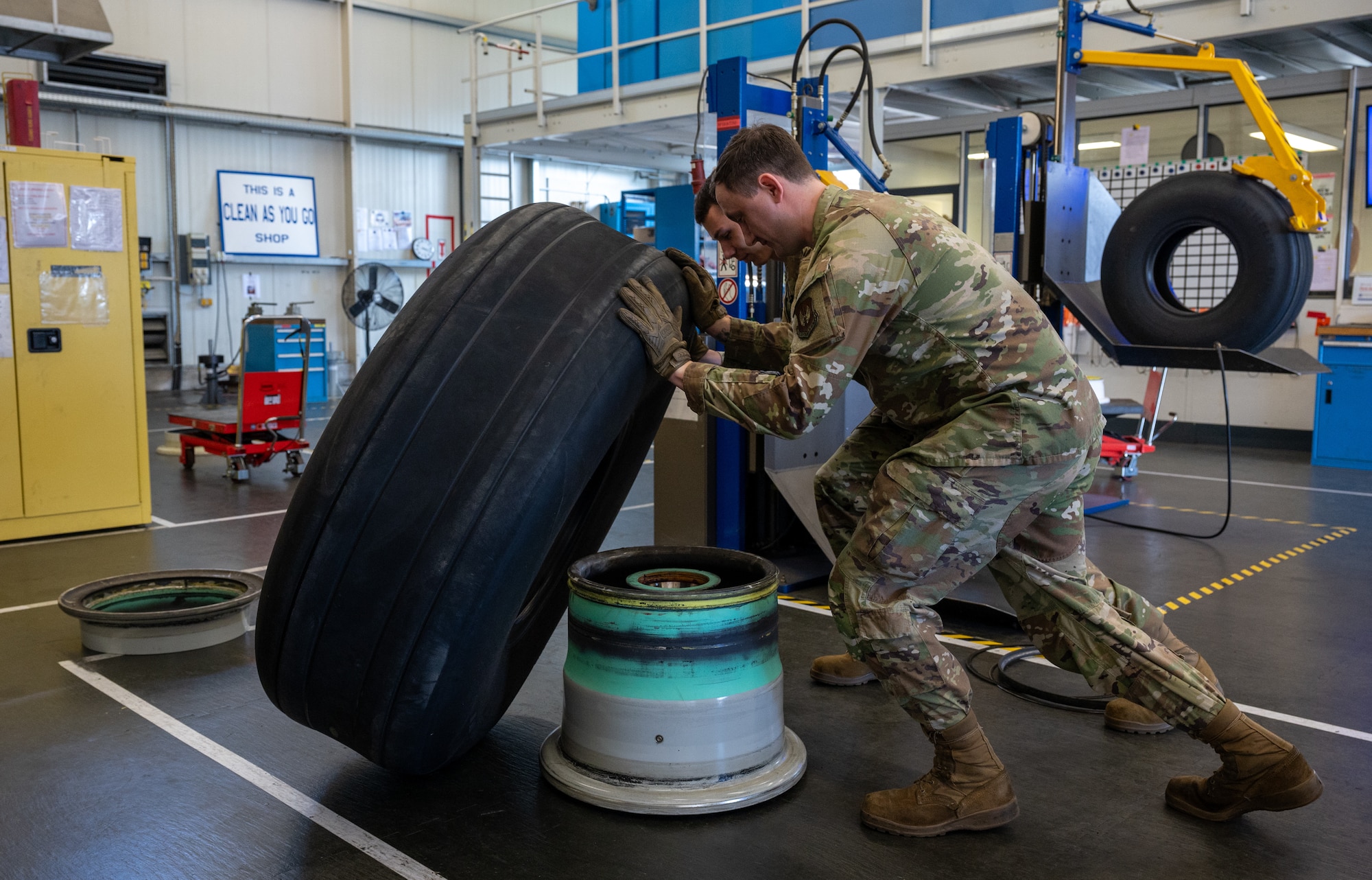 U.S. Air Force Jack Mueller and Senior Airman Andrew Bolek, 86th Maintenance Squadron repair and reclamation journeymen, dismount a C-130J Super Hercules main wheel assembly at Ramstein Air Base, Germany, Oct. 1, 2025. The Wheel and Tire Shop ensures every wheel that goes through their doors is inspected, tested and certified before returning it to the fleet. (U.S. Air Force photo by Senior Airman Jared Lovett)