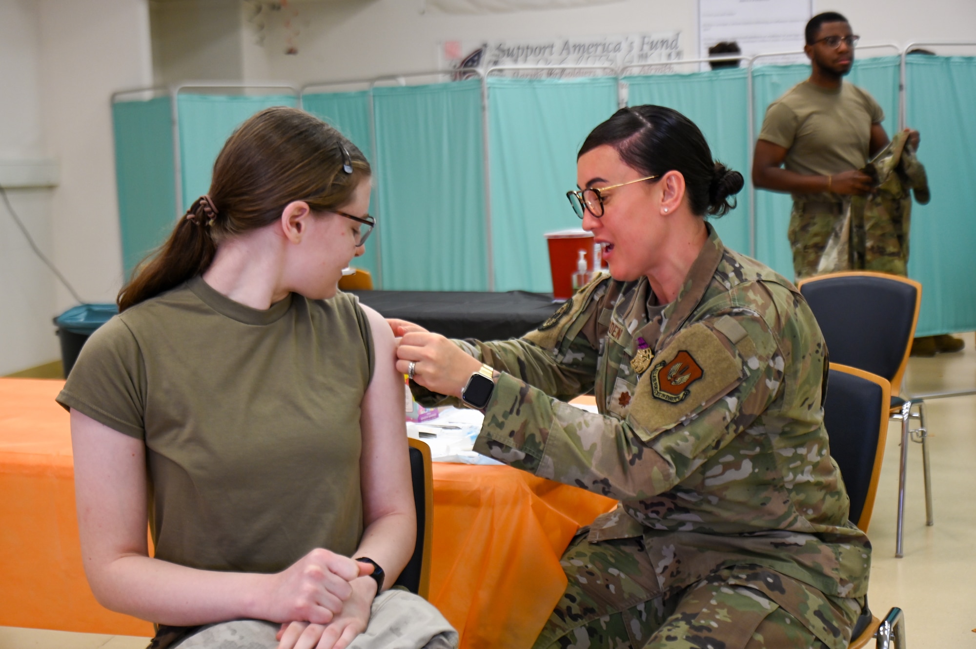 U.S. Air Force Maj. Debra Burden, 86th Medical Group primary care flight commander, administers a vaccine during an influenza point of distribution event at Ramstein Air Base, Germany, Oct. 21, 2025. The two week-long operation enabled medical personnel to vaccinate hundreds, protecting them ahead of the flu season. (U.S. Air Force photo by Airman 1st Class Rebecca Harima)