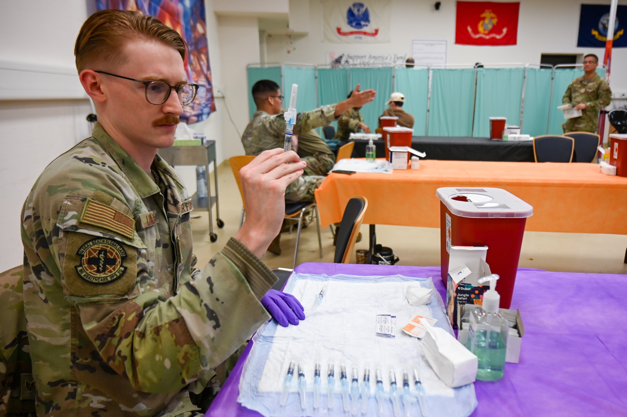 U.S. Air Force Staff Sgt. Brady Luallen, 86th Medical Group pediatric technician, prepares vaccines during an influenza point of distribution event at Ramstein Air Base, Germany, Oct. 21, 2025. The annual event encouraged preventative care by streamlining vaccinations at an easy-to-access centralized location for Ramstein service members. (U.S. Air Force photo by Airman 1st Class Rebecca Harima)